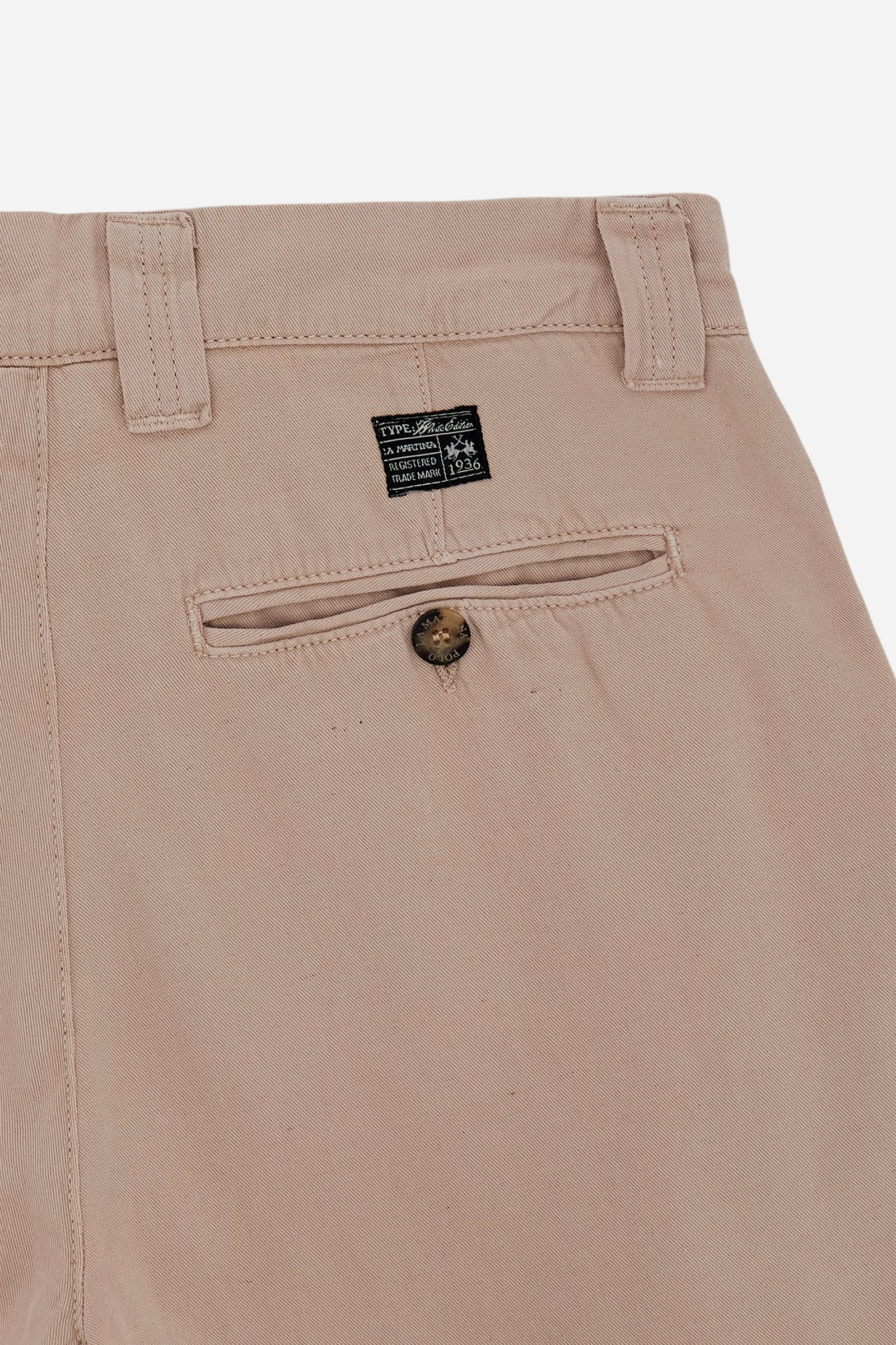 Men's chino trousers made from a lightweight cotton and linen blend fabric in solid color. The model features a classic zip and button closure, reinforced belt loops and side slant pockets. The back features welt pockets closed with customized horn-effect buttons. The regular cut with straight leg ensures comfort and freedom of movement. The Black Label Edition label is applied above the back pocket. The model is wearing size L. - Humus
