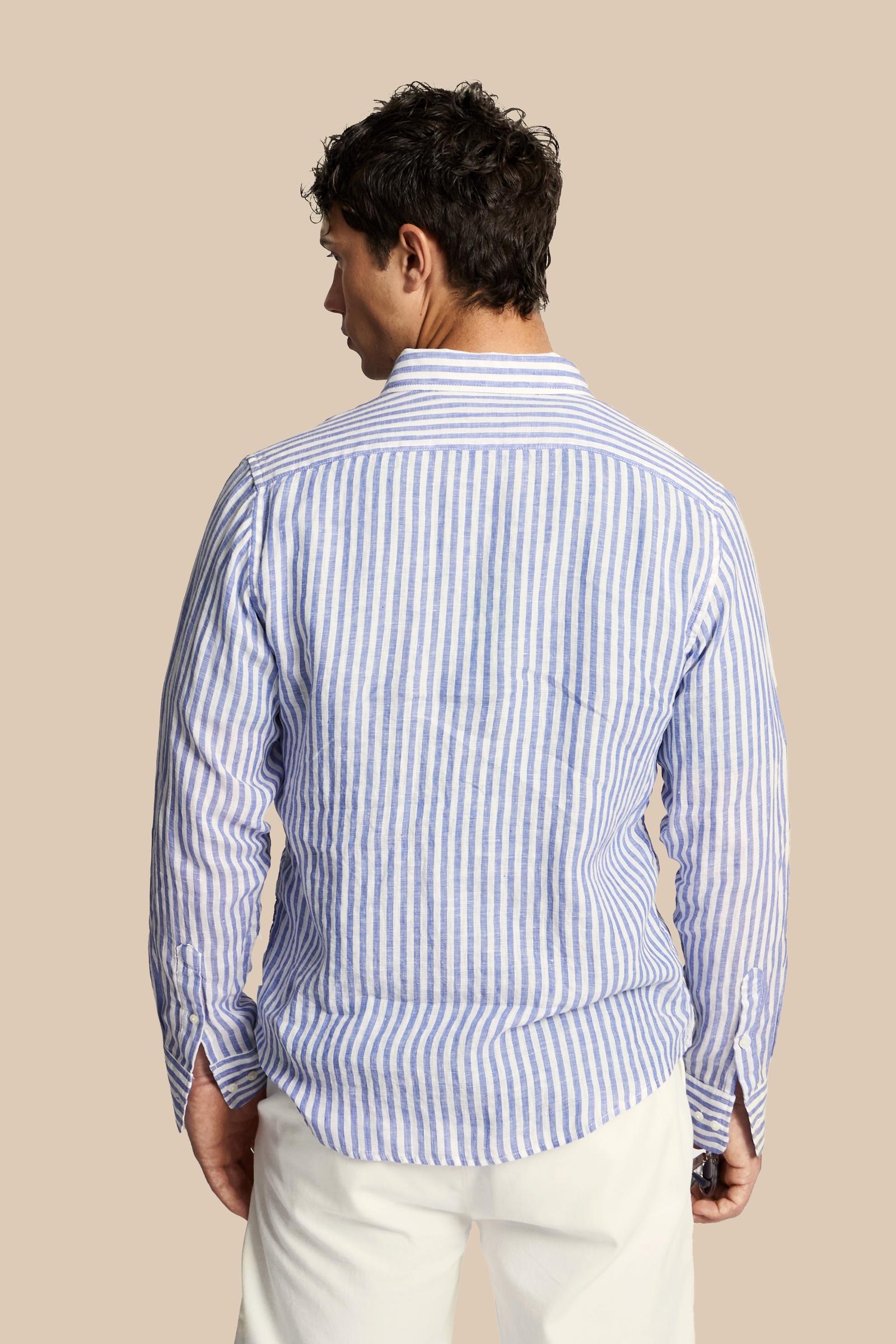 Men’s long-sleeve shirt crafted from 100% linen fabric with two-tone vertical stripes. Regular fit ensures comfort and versatility, complemented by a button-down collar and custom buttons. The iconic contrast embroidered logo on the chest signs the design with understated elegance. The model wears size L. - OptWhitePrincessBlue