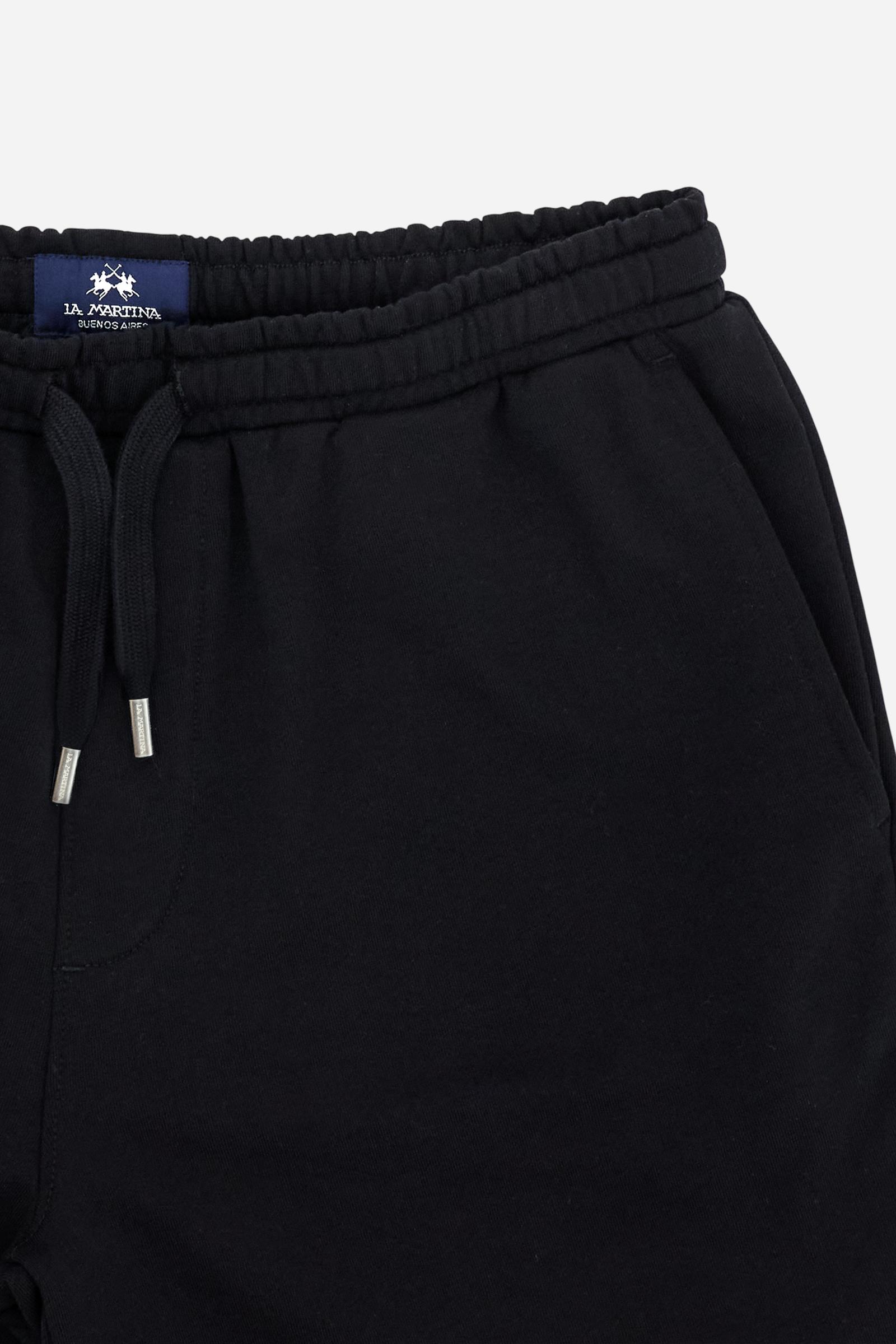 Men's bermuda shorts made from soft 100% cotton diagonal fleece. The regular relaxed cut reaches the knee and ensures maximum freedom of movement. The elastic waistband is completed by a flat tone-on-tone drawstring for adjustment. The design is finished with the brand's maxi logo embroidered in contrasting color with a 3D effect on the lower left leg. The model is wearing size L. - Black