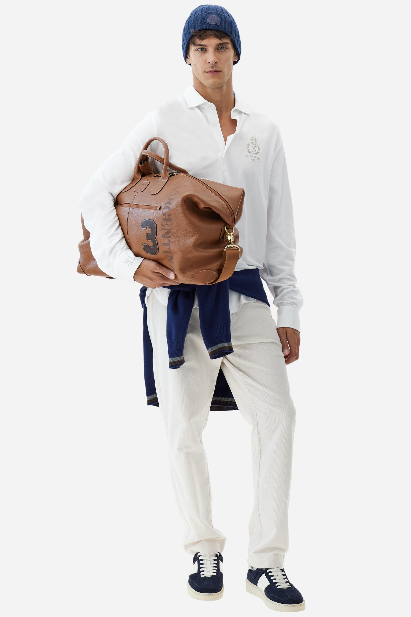 Men's long-sleeved shirt with semi-cutaway collar. It is made of 100% cotton piqué with contrasting details on the inside of the collar. The logo is embroidered on the chest with subtle Polo Club-inspired customisation. The fit is regular and offers a classic, relaxed silhouette. The model is wearing a size L. - Optic White