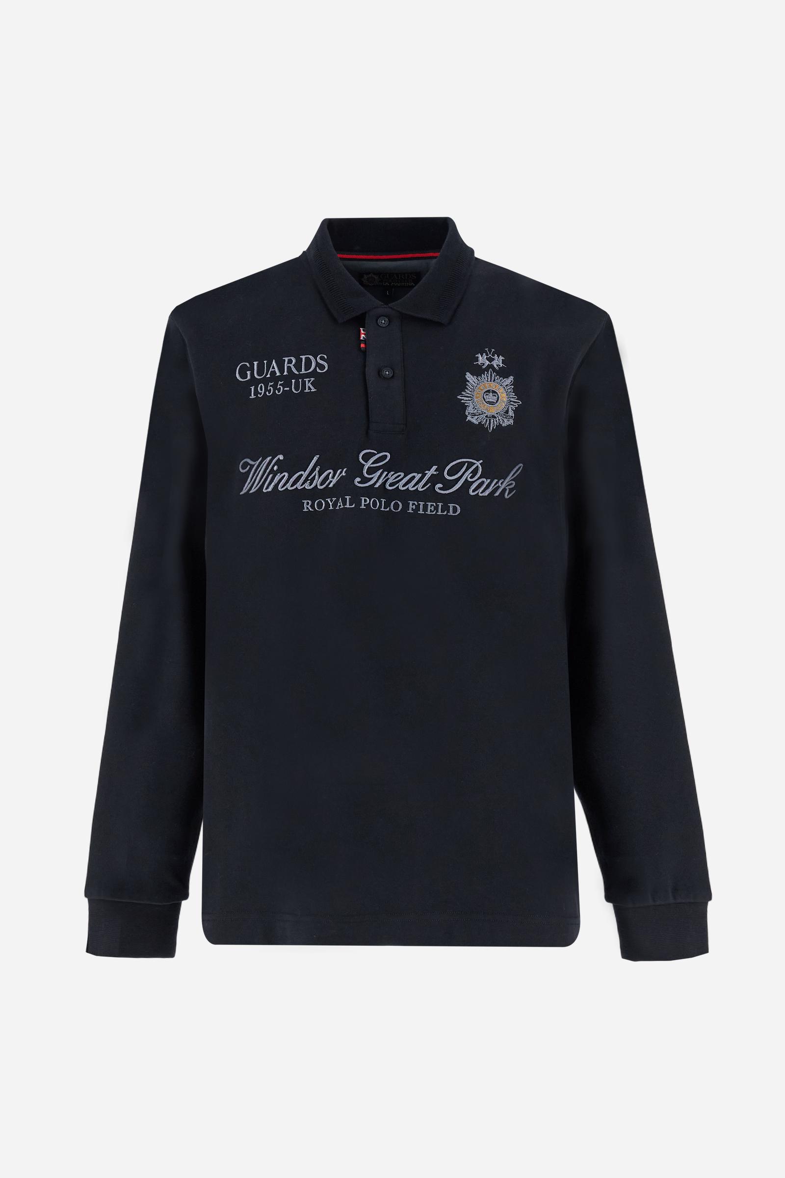 Long-sleeve polo shirt in warm cotton jersey. Ribbed collar with subtle textured detail, contrast undercollar and placket. Logo and Guards crest embroidered in contrast on the chest, paired with raised embroidered lettering inspired by Windsor tradition and British polo. Regular fit for an elegant yet relaxed style. Model wears size L. - Black