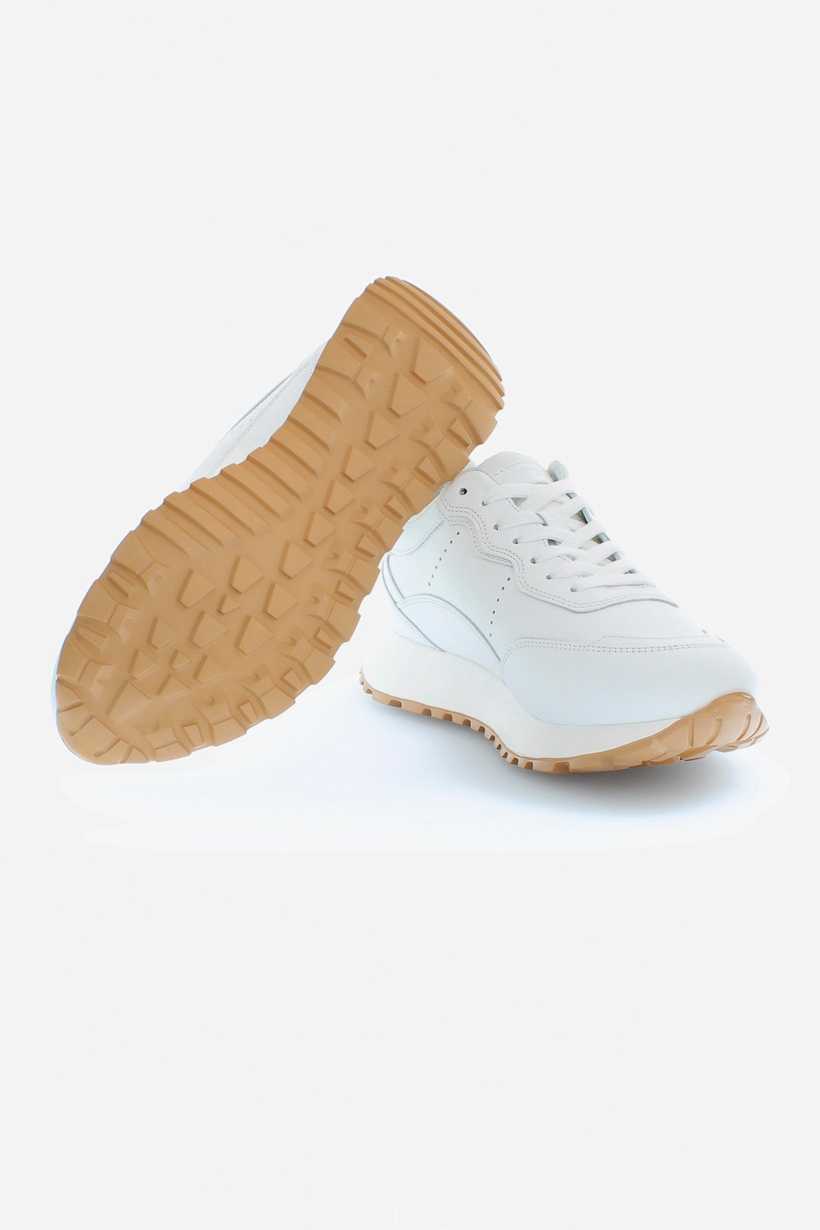 Women's sneakers in soft calfskin with tone-on-tone and contrasting leather inserts on the heel and sole. Two-tone bottom coordinated with the upper, featuring a contrasting rubber tread. The logo is embossed on the side band. Perfect for playing down a formal look or to combine with denim. - WHITE