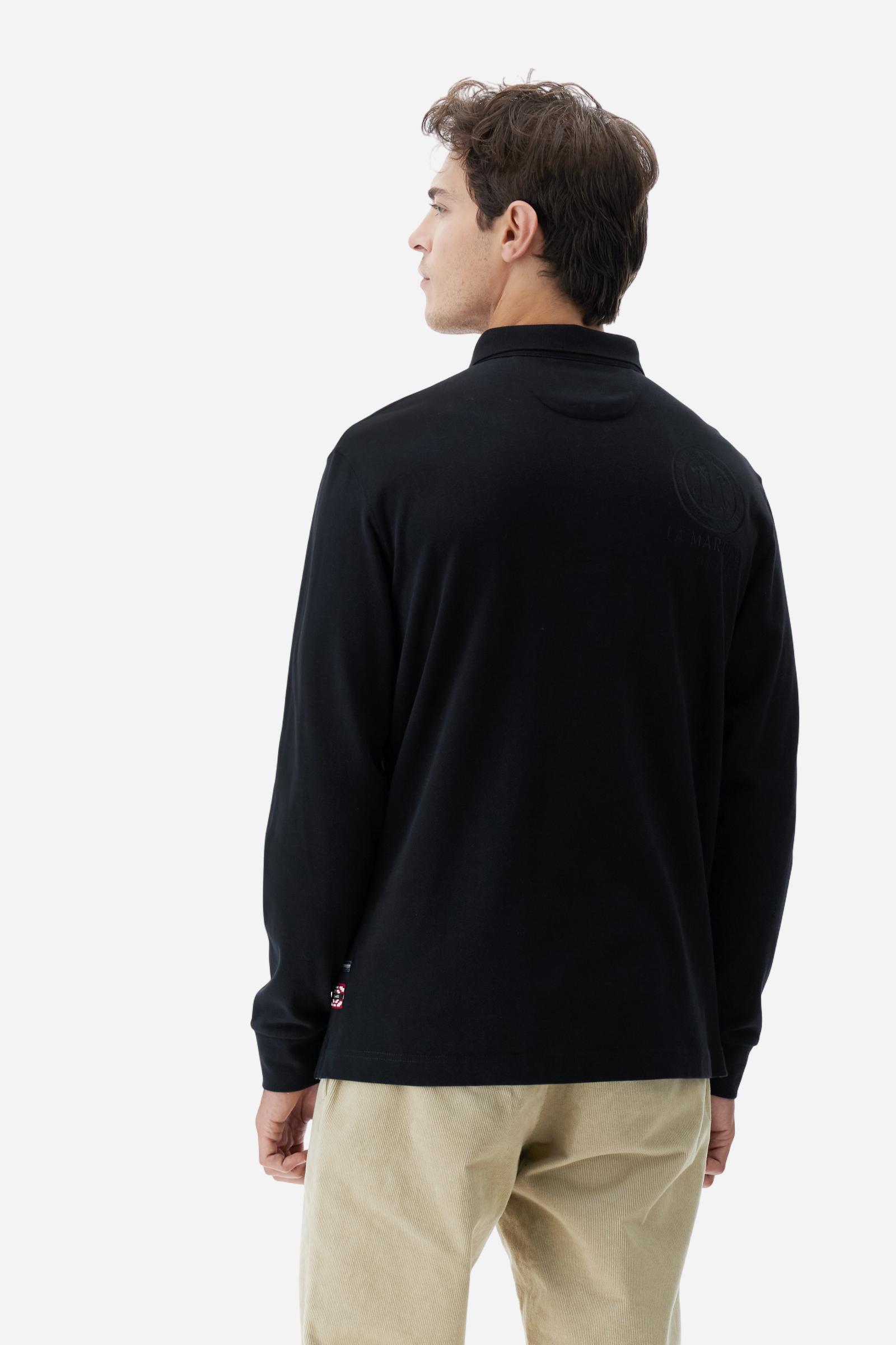 Long-sleeve polo shirt crafted from 100% high-quality cotton jersey. The velvety fabric offers a warm, cozy feel, perfect for cooler seasons. Ribbed collar and cuffs in matching tone, with a three-button personalized placket. A small multicolor embroidered logo sits below the opening, while tonal patches in different shapes and textures, inspired by Argentine culture and Gaucho tradition, decorate the chest and back. Classic regular fit. Model wears size L. - Black