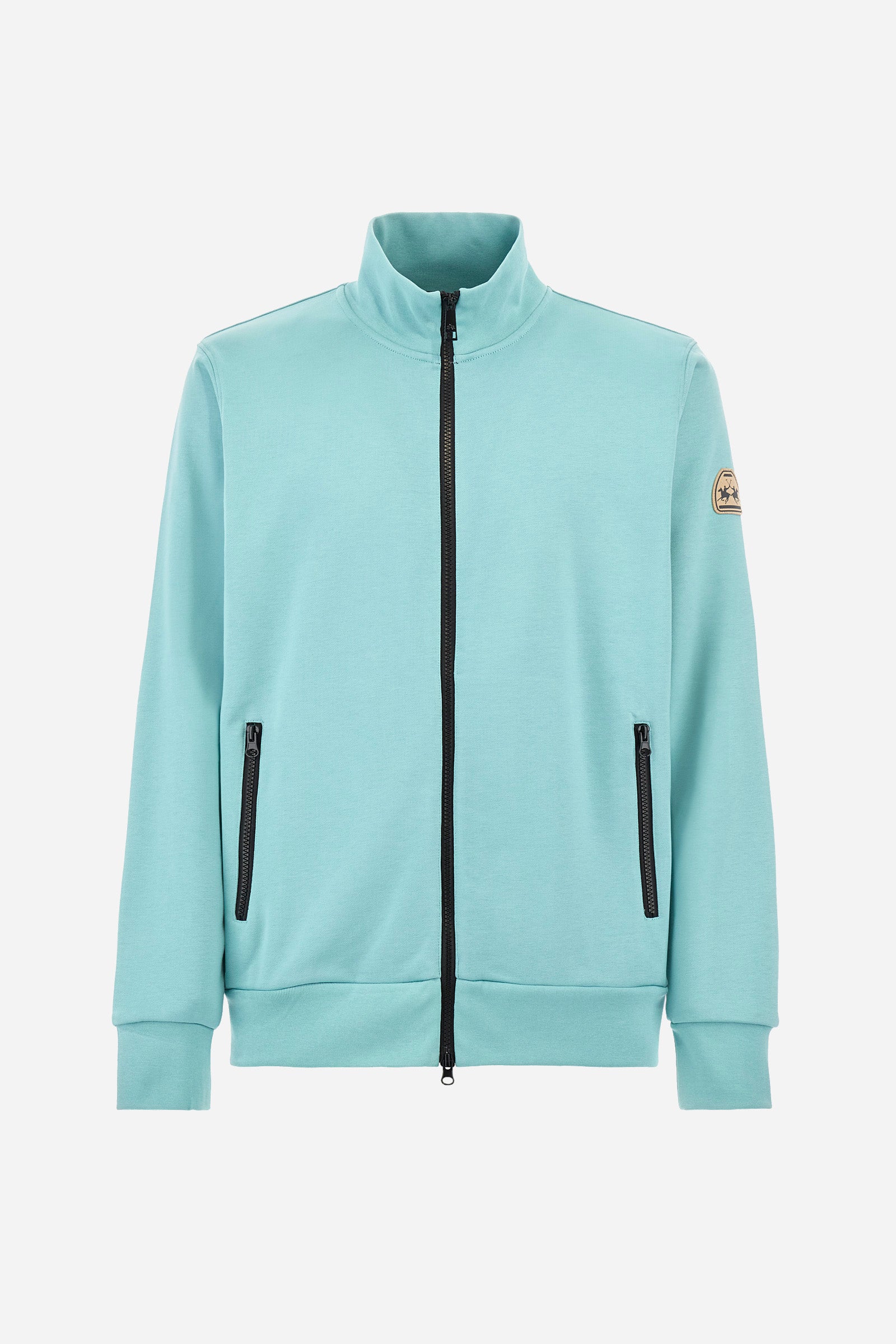 Men's long-sleeved solid-coloured sweatshirt with contrasting zip. Made of cotton. Equipped with a full zip and double front pocket, also with zip fastening. One sleeve features an applied logo patch. The fit is regular. The model wears a size L. - Aquifer