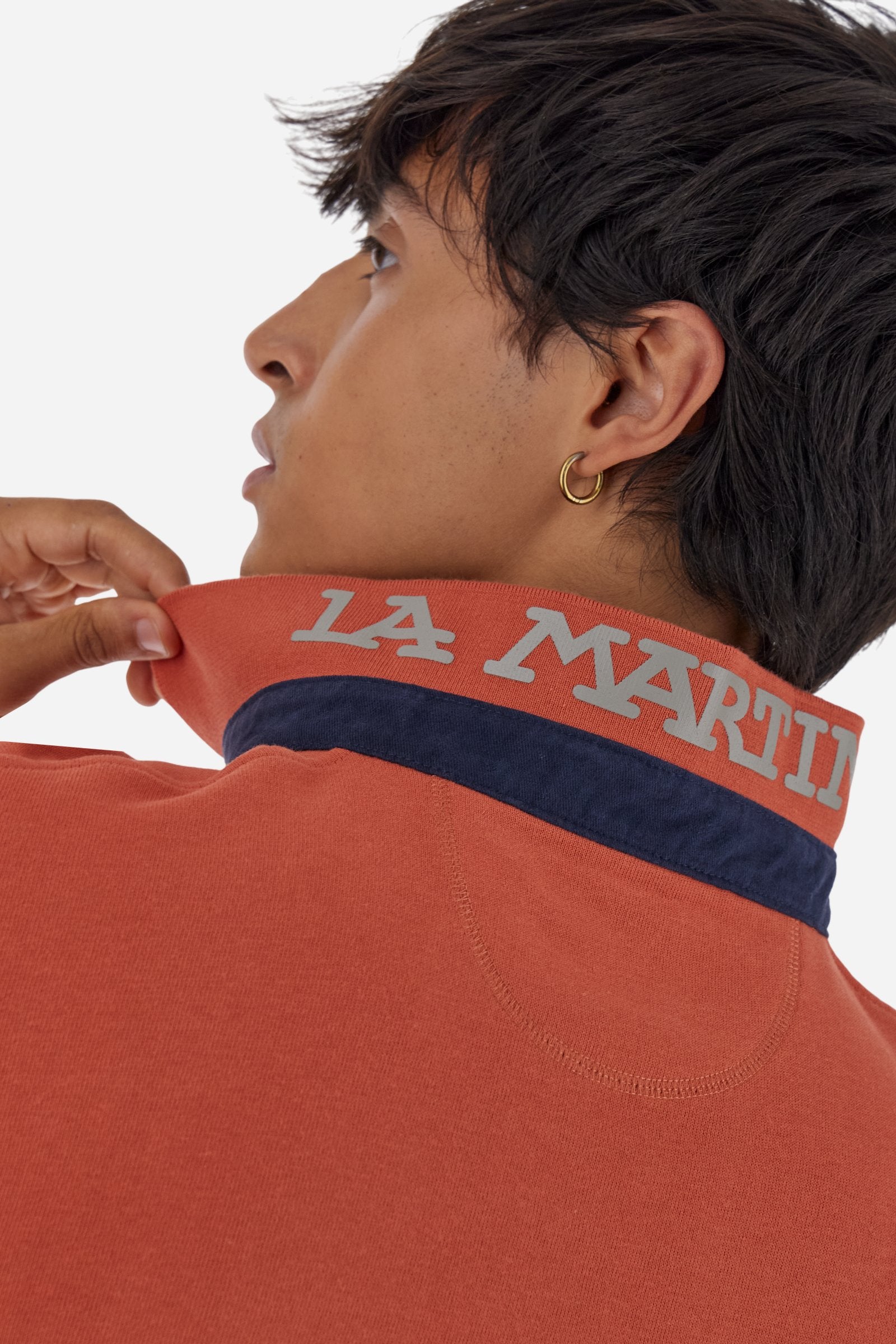 Men’s long-sleeve polo in premium soft-touch cotton jersey for a luxurious feel on the skin. Contrast gabardine details on the collar. Upper collar in tone-on-tone ribbing with printed La Martina lettering undercollar. Three customized buttons, enhanced by a multicolor striped tape on the placket. Contrast embroidered team logo on the chest. Regular fit. Model wears size L. - Burnt Ochre
