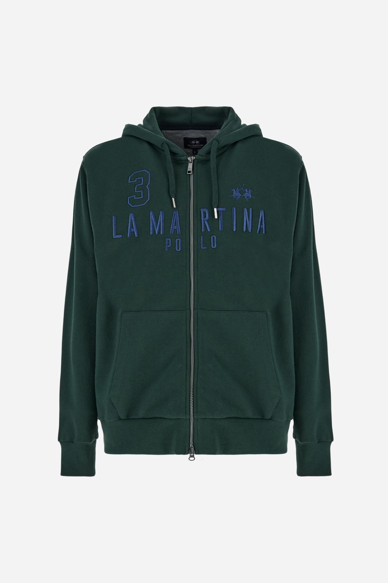 Men's long-sleeved hoodie in solid colour, made from soft 100% cotton fleece with a velvety touch. The model features a customised front zip and an adjustable hood with drawstring. Hem and cuffs in tone-on-tone rib. Iconic brand graphics stand out on the chest, embroidered with numbers and lettering. Regular fit ensuring comfort and freedom of movement. Model wears size L. - Sycamore