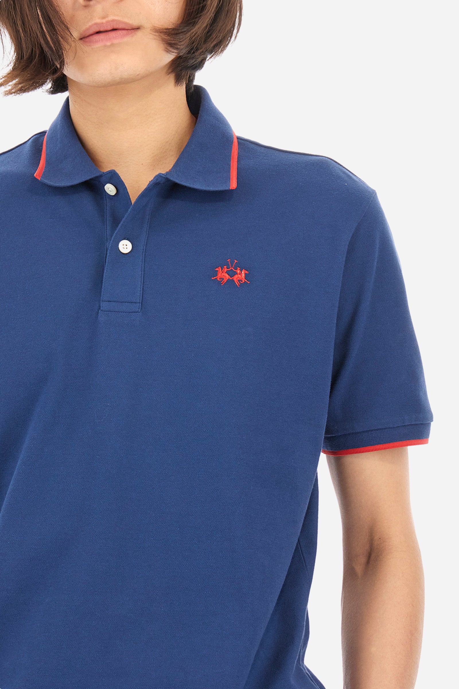 Men’s polo with short sleeves in stretch pique cotton. A classic La Martina, with a simple and linear style. The regular fit fits easily to any type of silhouette. A small La Martina logo is embroidered on the chest, in contrasting shades like the sleeve edge. The model is 187 cm tall and wears a size L. - Ensign Blue