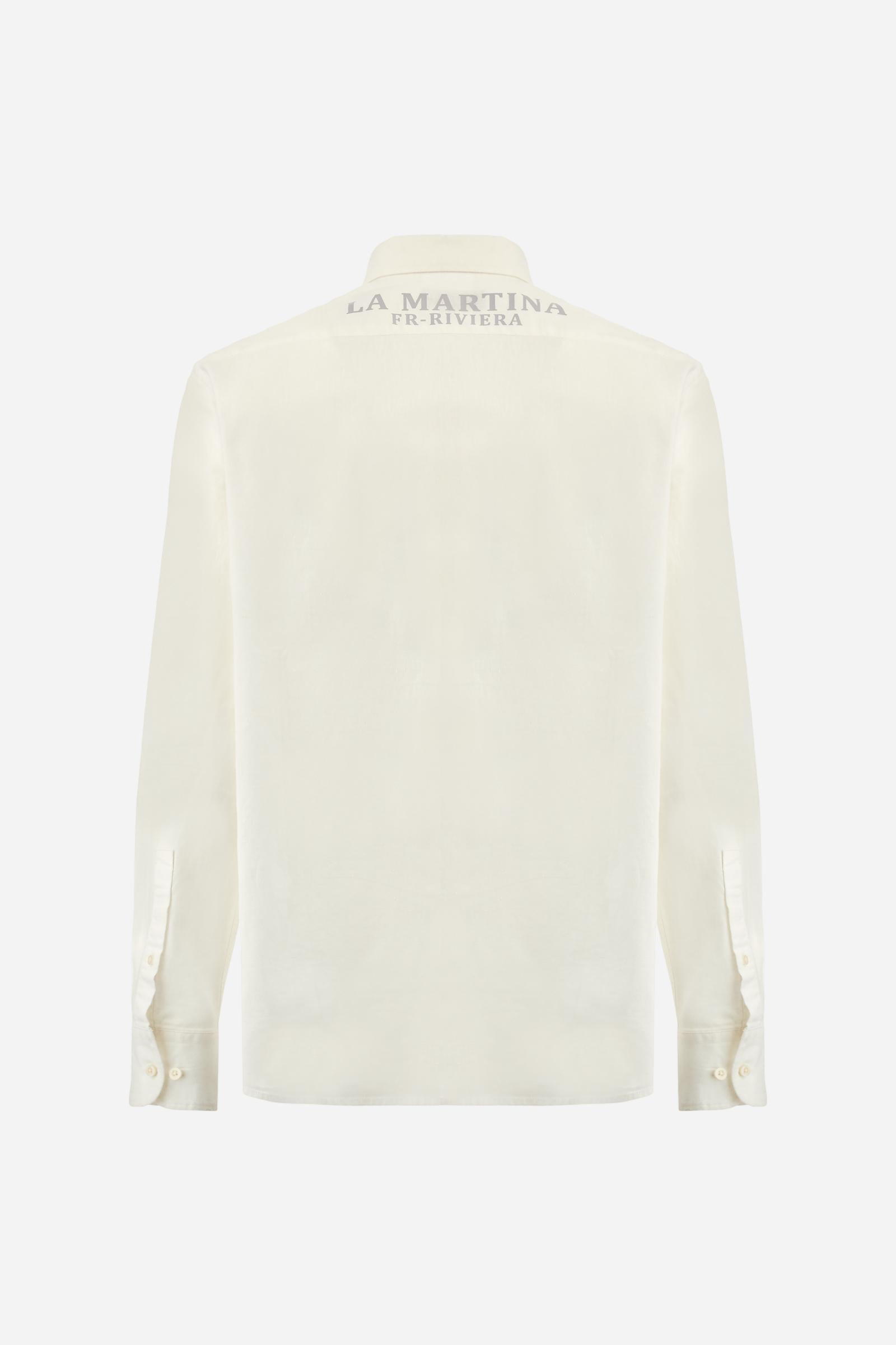 Men's plain long-sleeved shirt, made from luxurious cotton and linen canvas. The spread collar and the opening, which reaches the waist, are closed with 4 buttons. The left bicep is embellished with embroidered graphics depicting lettering, crests and numbers, created using contrasting thread. The logo is embroidered in contrasting thread on the left side of the chest. The regular fit offers a refined and comfortable look. The model is wearing a size L. - Optic White