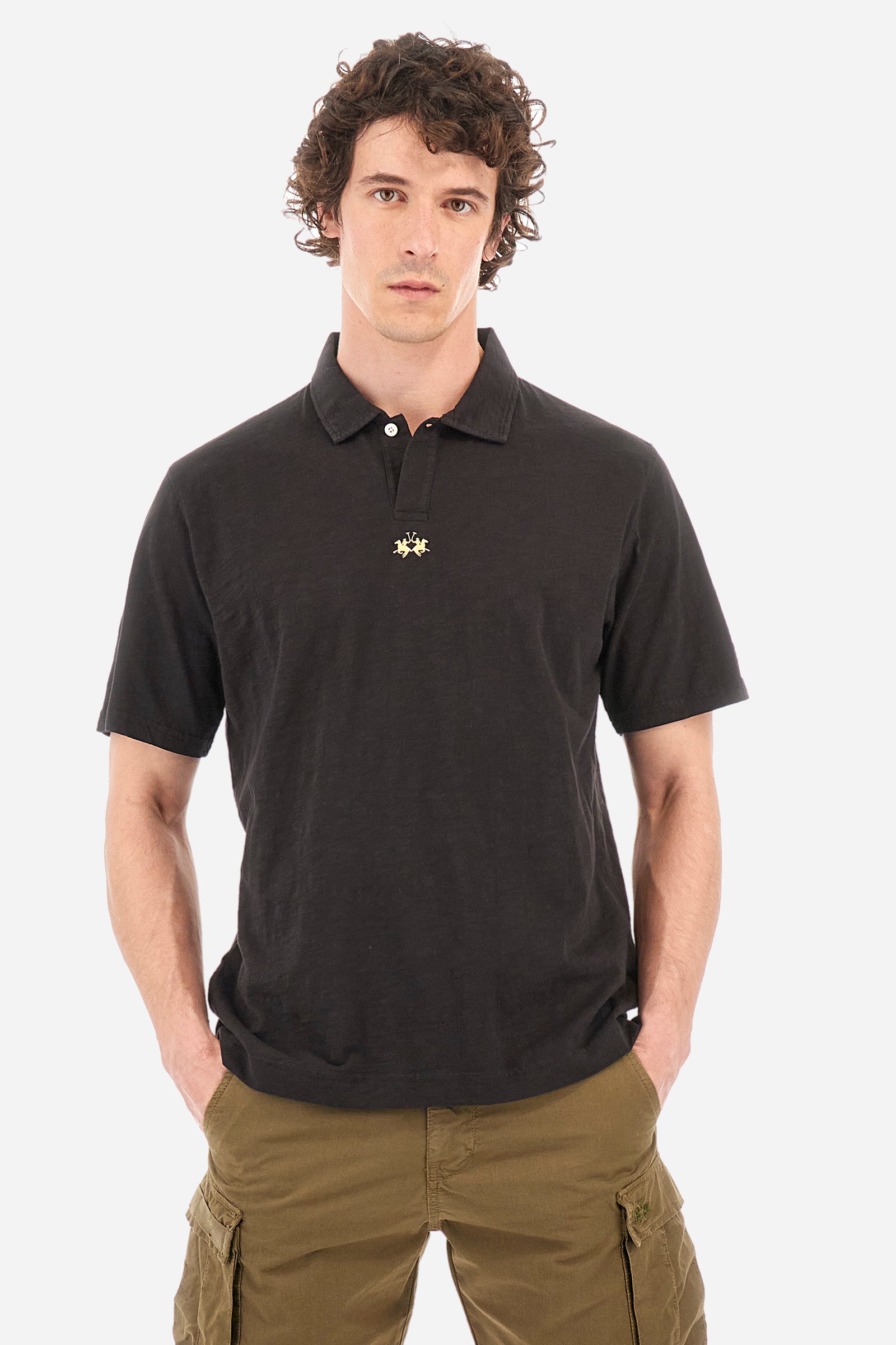 This is the iconic Polo 19-42 from La Martina. Men's short-sleeved polo shirt in solid color made of 100% slub jersey. With a regular fit, it has a collar and a double button closure while the La Martina logo is embroidered in small gold on the front under the placket. Ideal when worn with denim from the collection. Each Polo is kept in an exclusive logoed envelope and is accompanied by a certificate of guarantee. The model is 187 cm tall and wears a size L. - Black