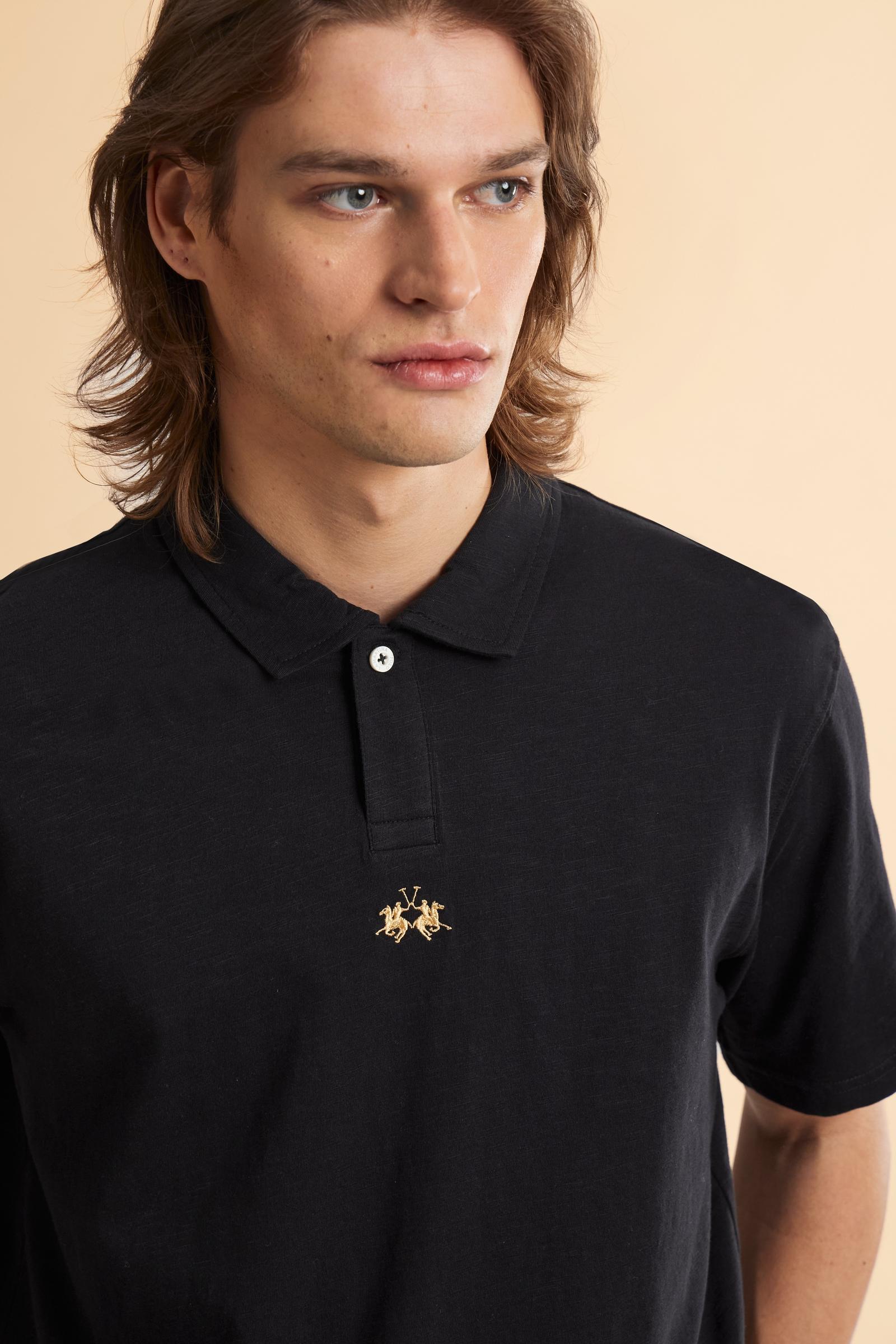 This is the iconic Polo 19-42 from La Martina. Men's short-sleeved polo shirt in solid color made of 100% slub jersey. With a regular fit, it has a collar and a double button closure while the La Martina logo is embroidered in small gold on the front under the placket. Ideal when worn with denim from the collection. Each Polo is kept in an exclusive logoed envelope and is accompanied by a certificate of guarantee. The model is 187 cm tall and wears a size L. - Black