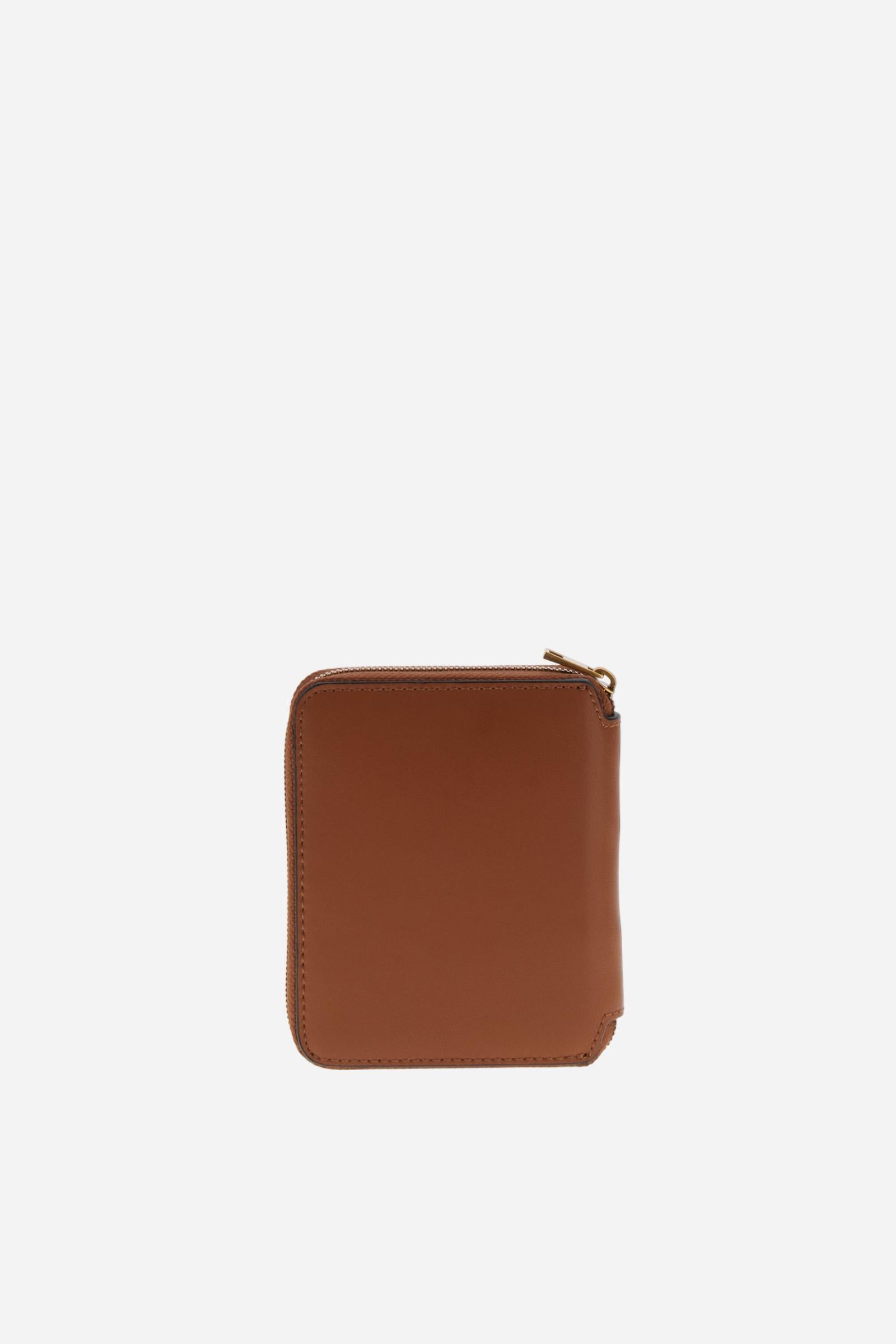 Small zip around wallet in calfskin leather. Compact and practical, with golden zip and branded metal detail. - COGNAC