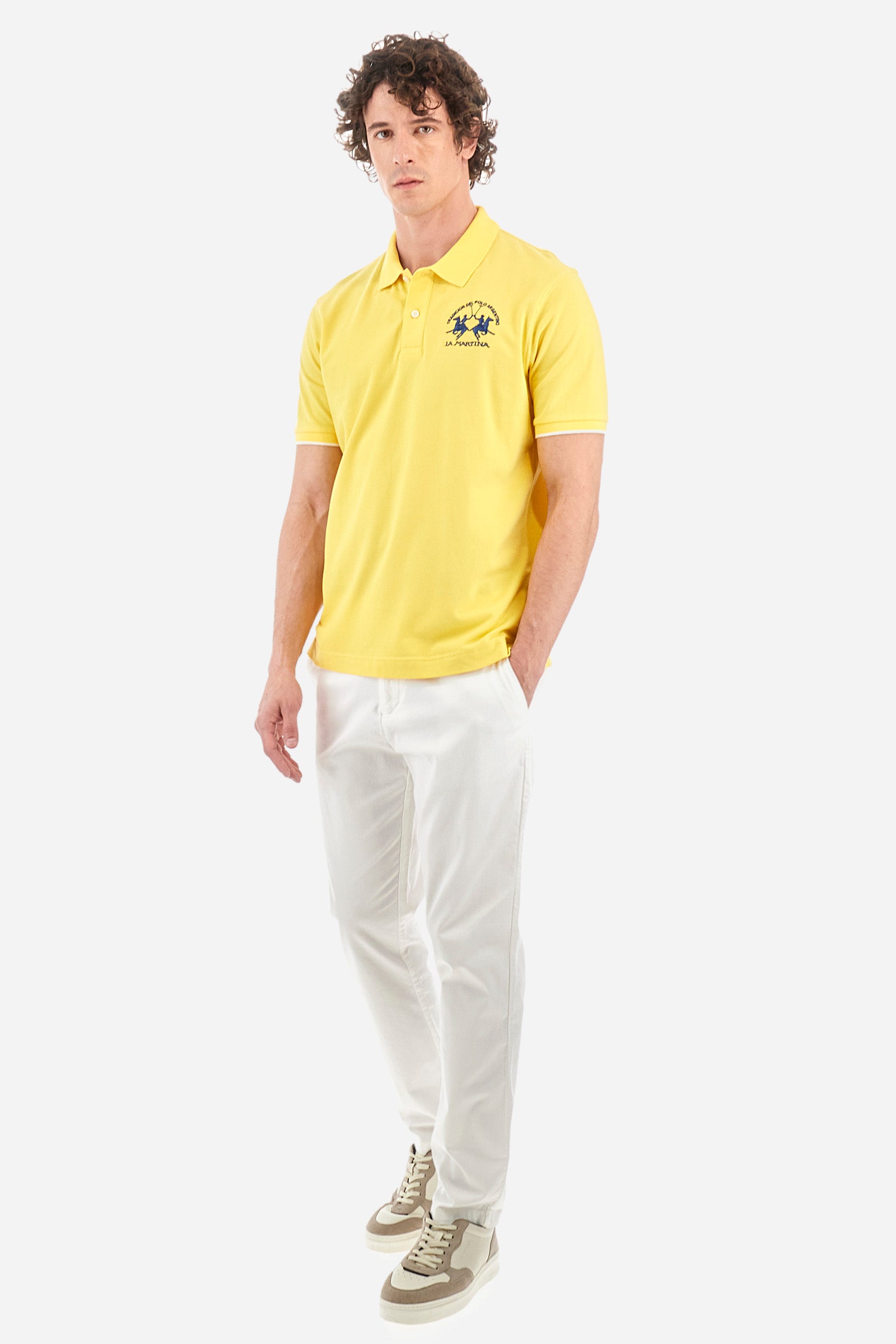 Men’s polo with short sleeves, regular fit. Made of stretch pique cotton. Classic model, with large embroidered logo in contrasting tone on the chest and profiled sleeve edges. The collar is accompanied by the writing La Martina, in contrasting tone. Ideal if worn with a denim collection. The model wears a size L. - Aspen Gold