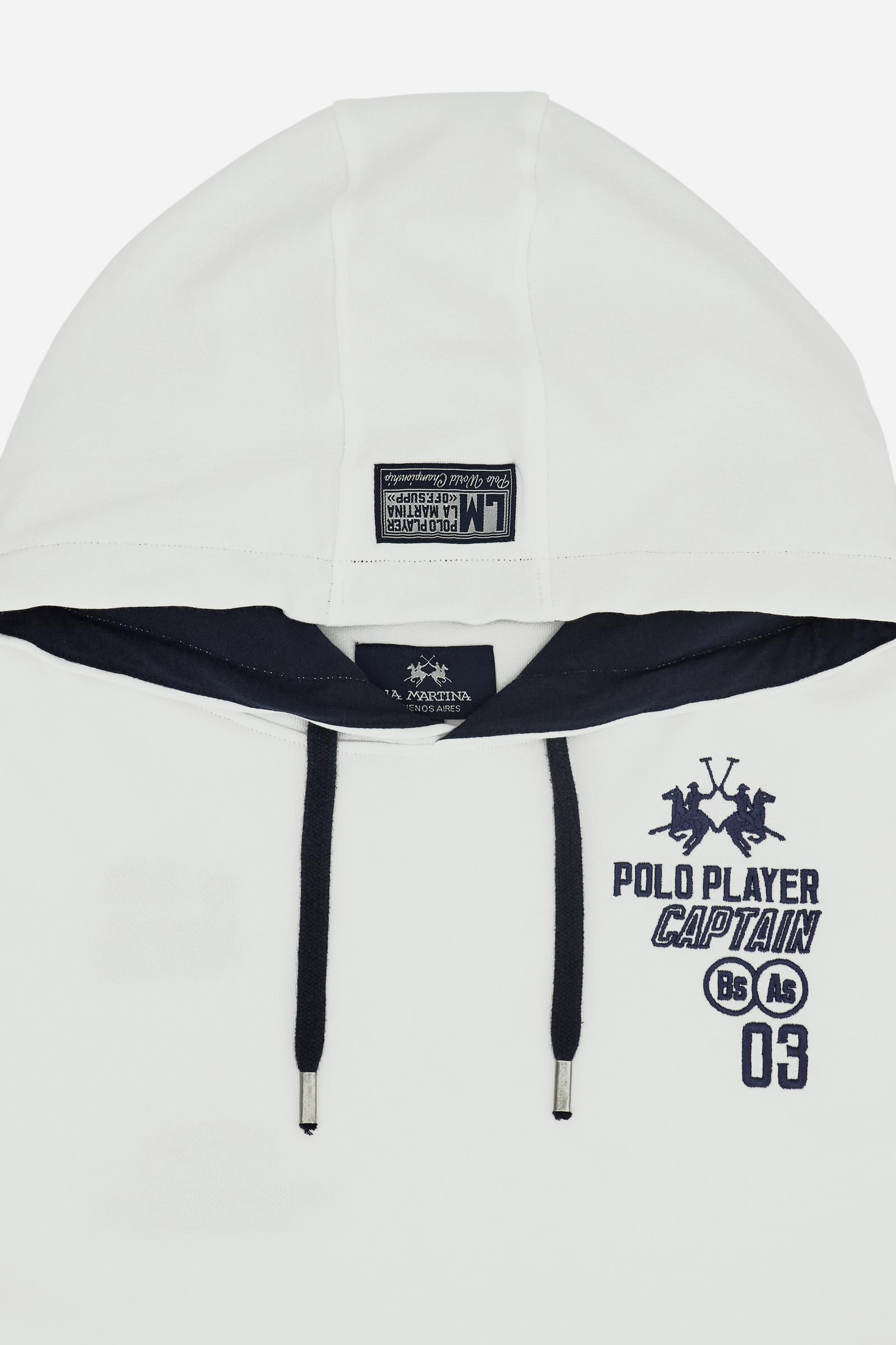 Men’s long-sleeve cotton French terry sweatshirt with a contrast jersey-lined hood, ribbed cuffs, navy embroidery, and a bold Argentina print on the back. - Optic White