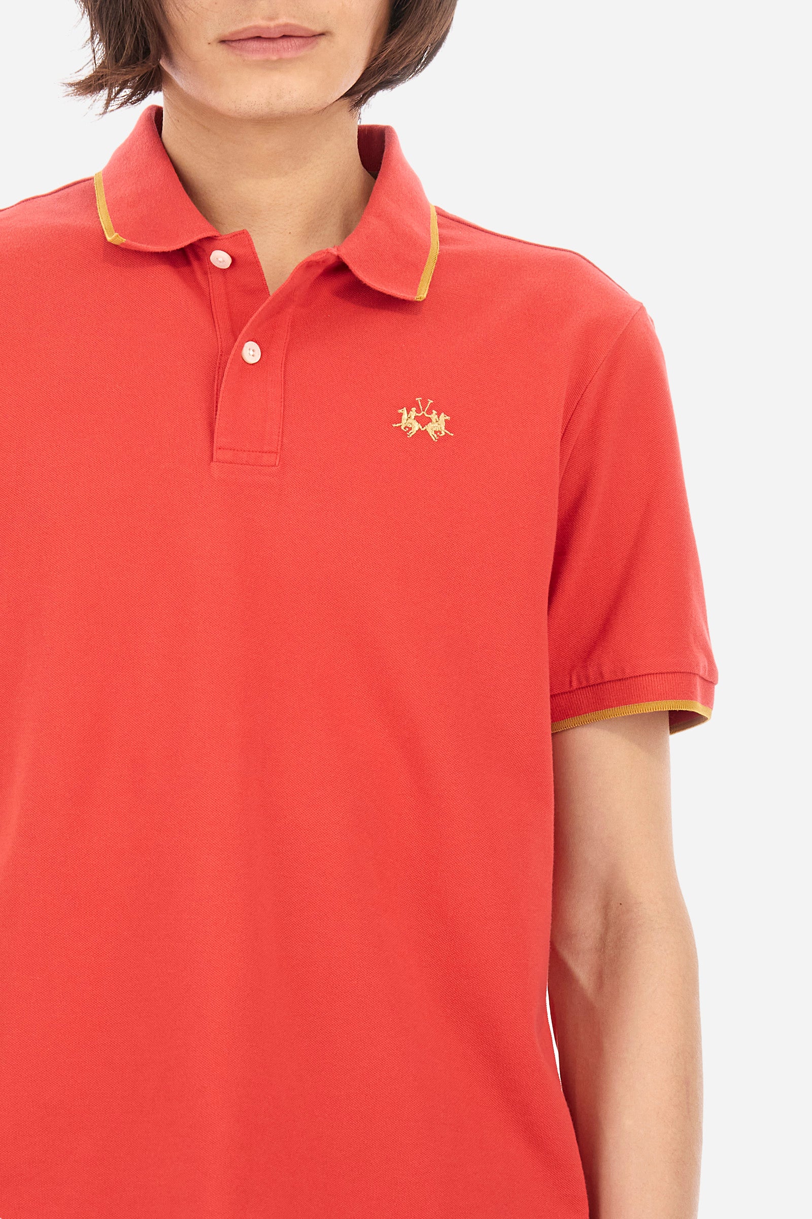 Men’s polo with short sleeves in stretch pique cotton. A classic La Martina, with a simple and linear style. The regular fit fits easily to any type of silhouette. A small La Martina logo is embroidered on the chest, in contrasting shades like the sleeve edge. The model is 187 cm tall and wears a size L. - Poinsettia