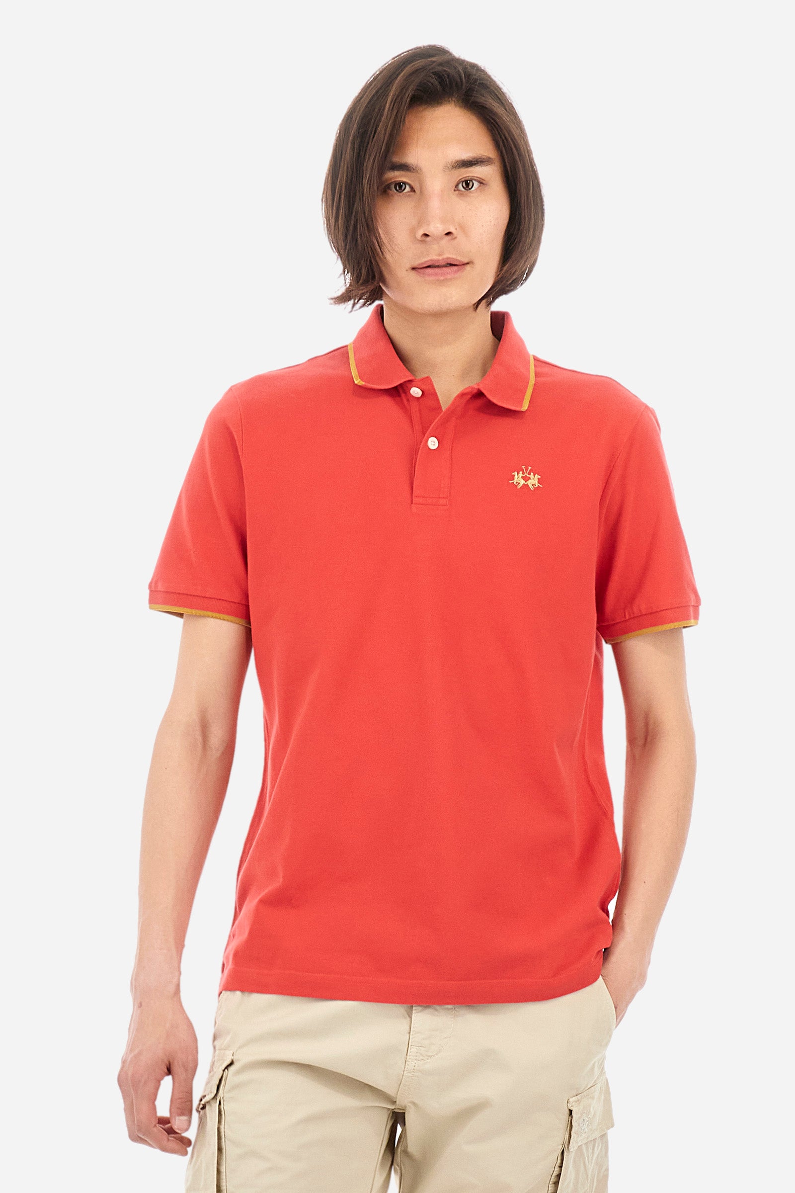 Men’s polo with short sleeves in stretch pique cotton. A classic La Martina, with a simple and linear style. The regular fit fits easily to any type of silhouette. A small La Martina logo is embroidered on the chest, in contrasting shades like the sleeve edge. The model is 187 cm tall and wears a size L. - Poinsettia