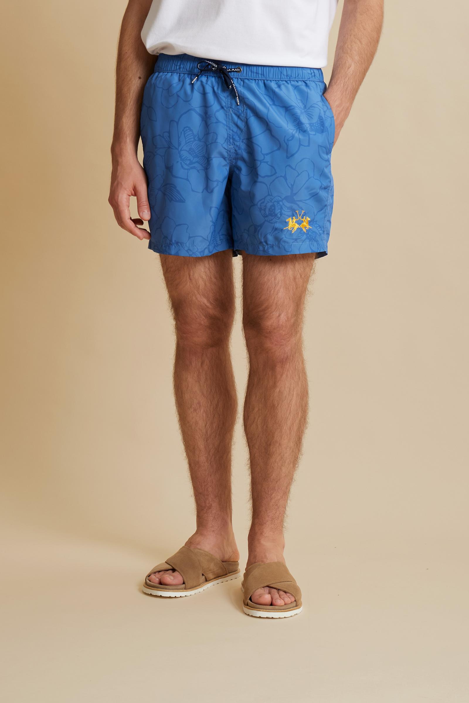Men’s nylon swim shorts with floral print. Mid-length design with elasticated waistband, drawstring and contrasting embroidered logo. - Riviera/Dutch Blue