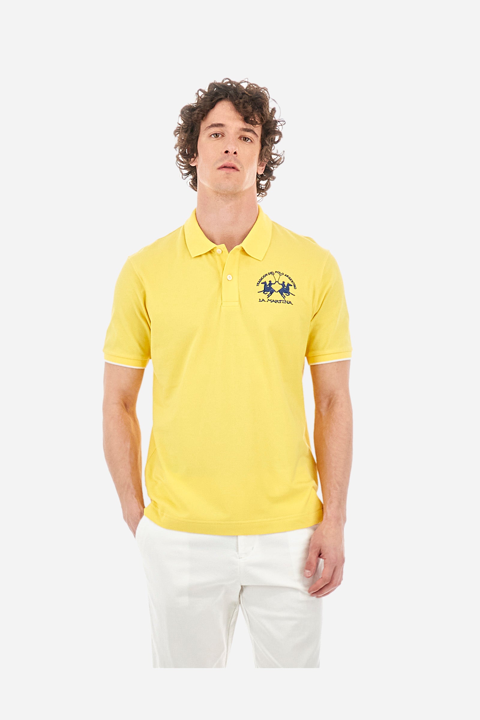 Men’s polo with short sleeves, regular fit. Made of stretch pique cotton. Classic model, with large embroidered logo in contrasting tone on the chest and profiled sleeve edges. The collar is accompanied by the writing La Martina, in contrasting tone. Ideal if worn with a denim collection. The model wears a size L. - Aspen Gold