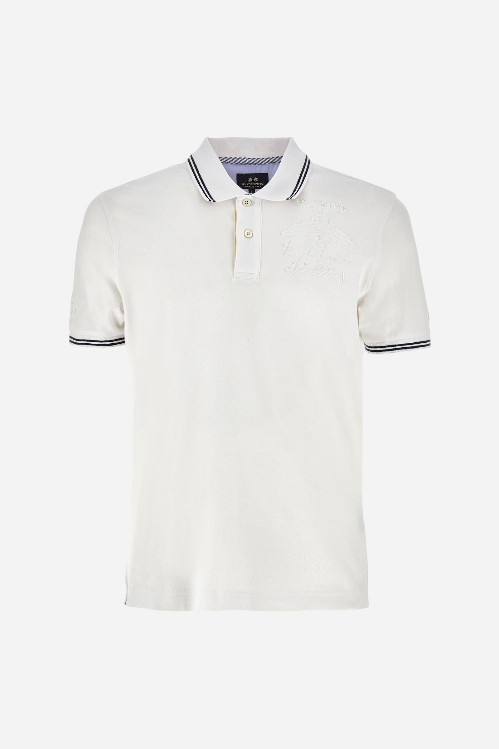 Men's plain short-sleeved polo shirt made from stretch piqué. Two-button fastening. The collar and cuffs are made from two-tone striped ribbed fabric. The inside of the collar and placket feature contrasting fabrics and colours. There is a two-tone striped band around the inside of the collar. The right sleeve and chest are embroidered in tone-on-tone thread. A logo is embroidered on the left sleeve, also using tone-on-tone thread. Regular fit. The model is wearing a size L. - Optic White