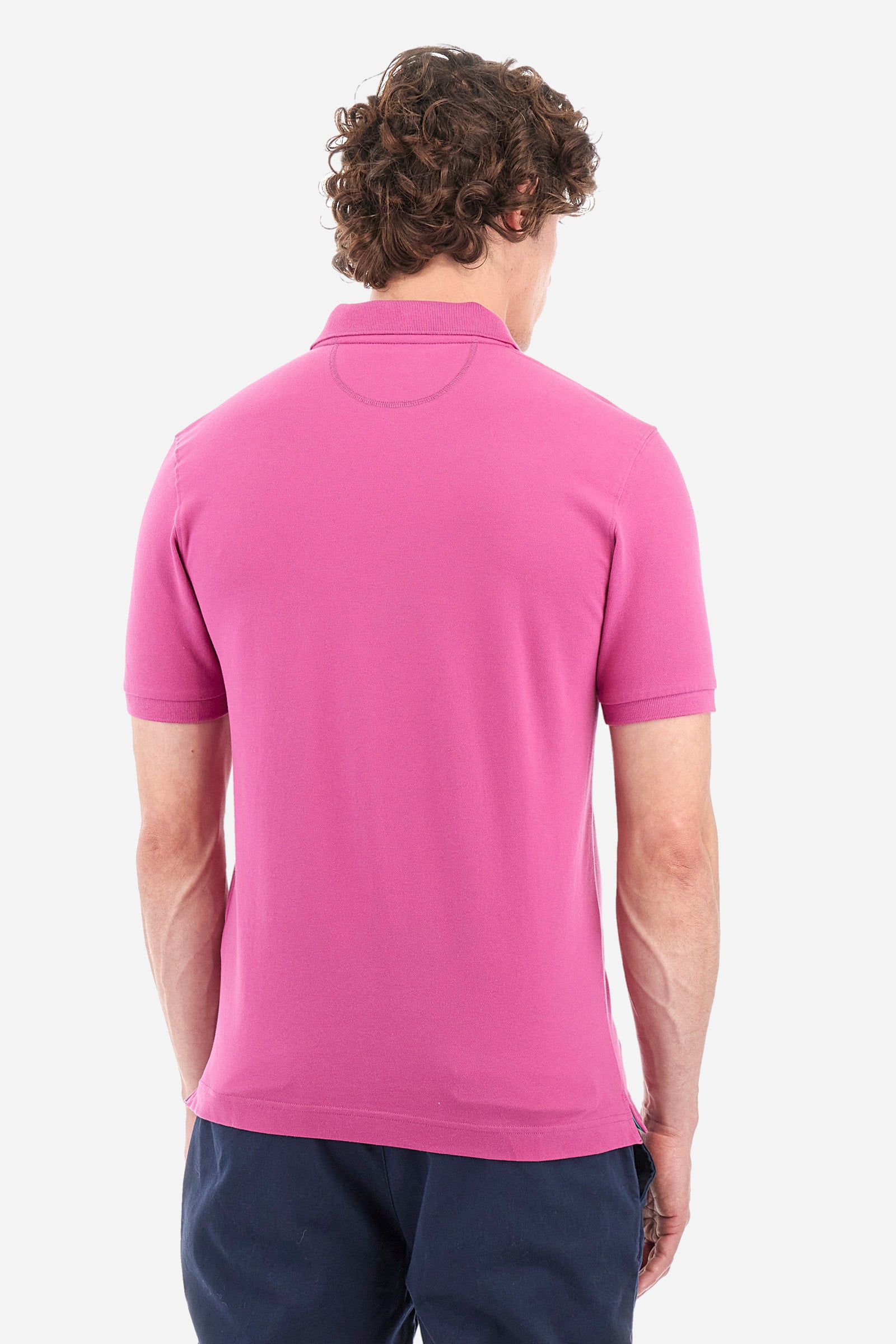 Men's single-colour short-sleeved polo in elasticated cotton. Two-button fastening. Tone-on-tone stitching. Ribbed collar and armholes. The "La Martina" lettering can be found under the collar. Featuring a small logo embroidered on the chest. In a slim fit. The model wears a size L. - Purple Wine