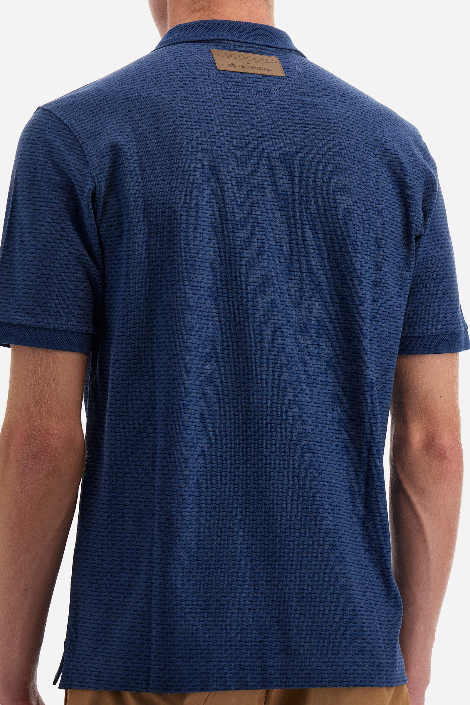 Single-colour men's polo shirt with short sleeves from the line in collaboration with Pagani. Made of stretch cotton. Two-button fastening. The collar and armholes feature a different texture. The garment features lettering throughout. A patch with the brand's name and logo and the word "Pagani" is applied on the back. The fit is regular. The model wears a size L. - ENSIGNBLUE/NAVYBLAZE