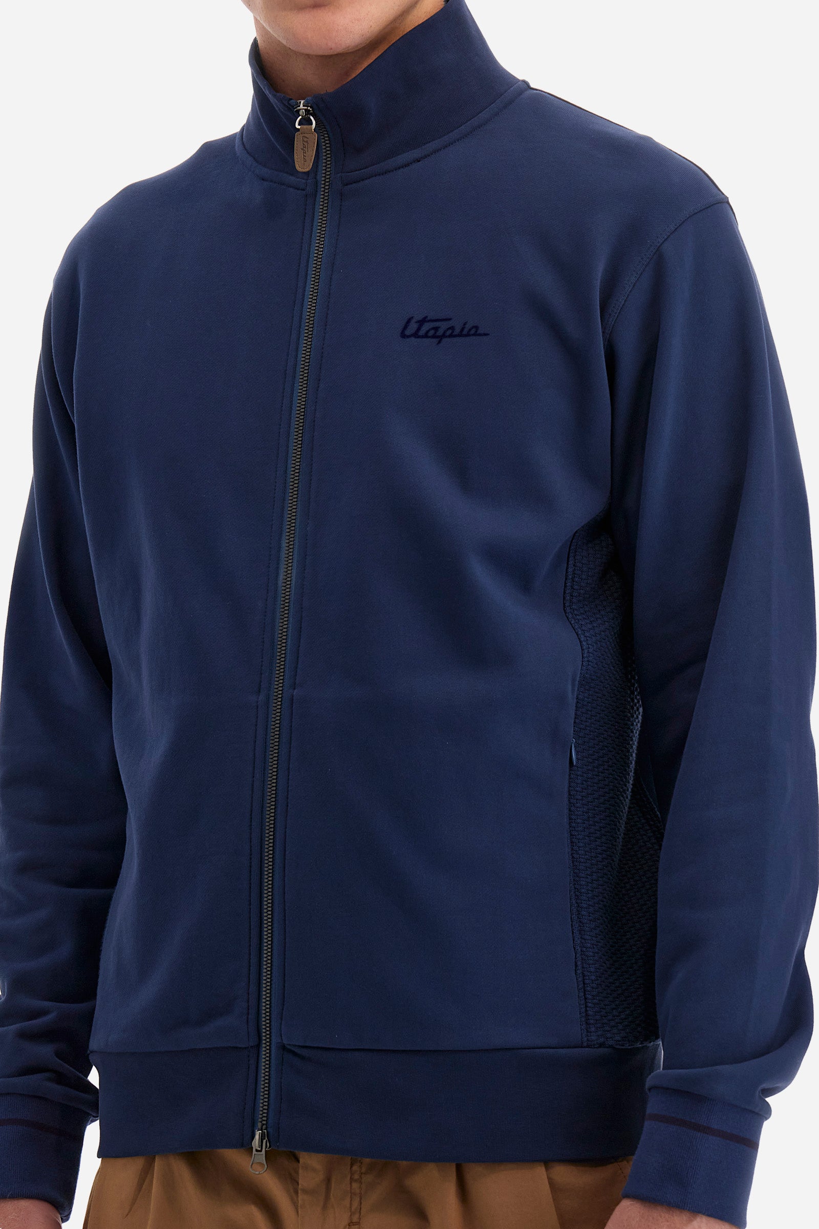 Single-colour long-sleeved men's sweatshirt with full zip fastening from the line in collaboration with Pagani. Made of 100% cotton. Mock neck, ribbed waistband and cuffs. Double back pocket. On the sides the garment has a different texture from the main part. There is lettering on the front, while a plate featuring the La Martina logo and the Pagani logo is sewn on the back. The fit is regular. The model wears a size L. - Ensign Blue