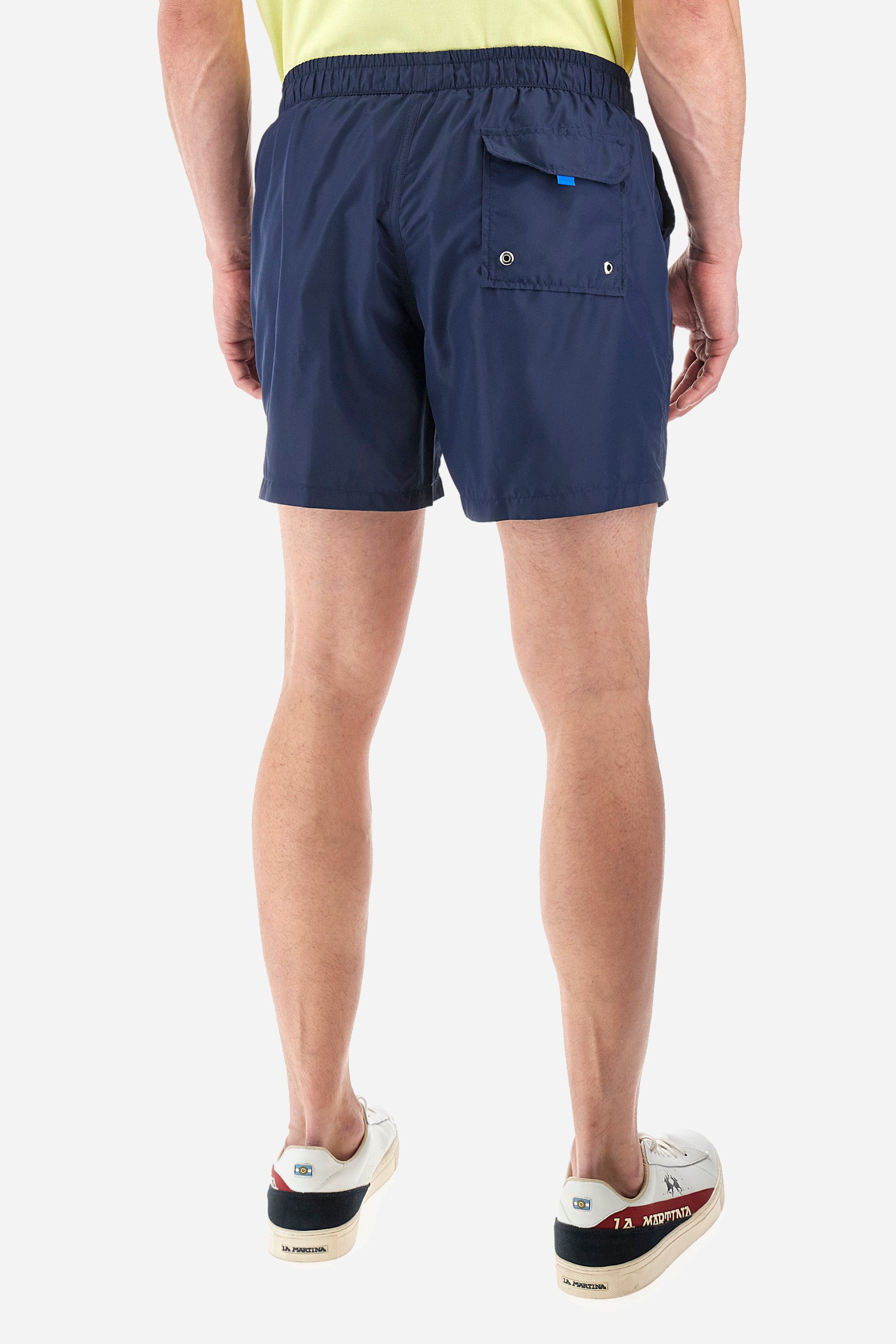 Single-colour men's swimming shorts, made of synthetic fabric. Featuring a drawstring and tie with "La Martina" lettering. Double welt pocket on the front. Closed pocket on the back. Mesh lining. Large logo embroidered on the front. The fit is regular. The model wears a size L. - Navy