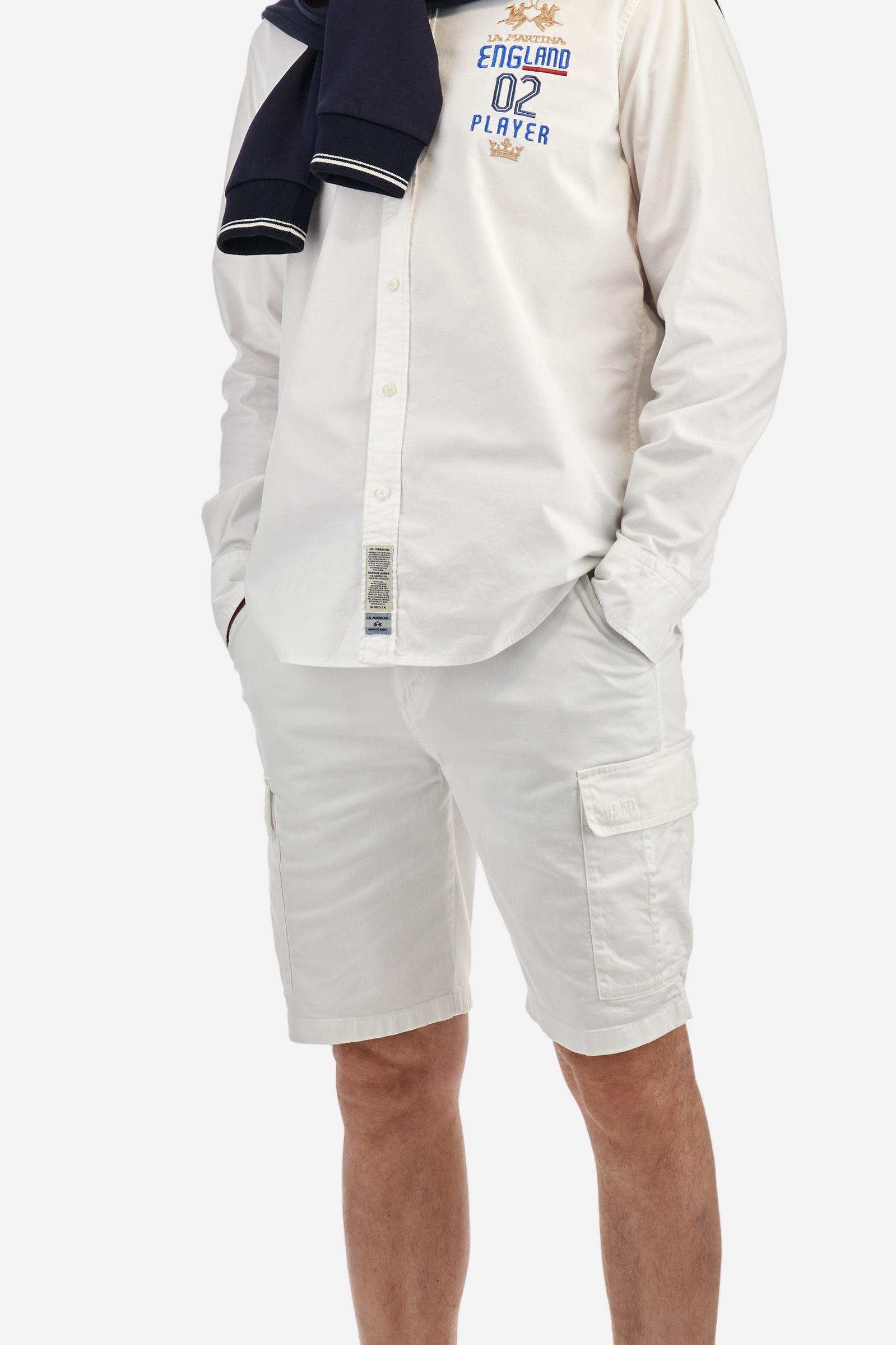 Men's long-sleeved plain shirt made from 100% Oxford cotton. The button-down collar is finished with a second button printed with the English flag. The multicoloured embroidery on the chest, over the heart, includes lettering, numbers and the logo, which add a distinctive touch. Regular fit. The model is wearing a size L. - Optic White