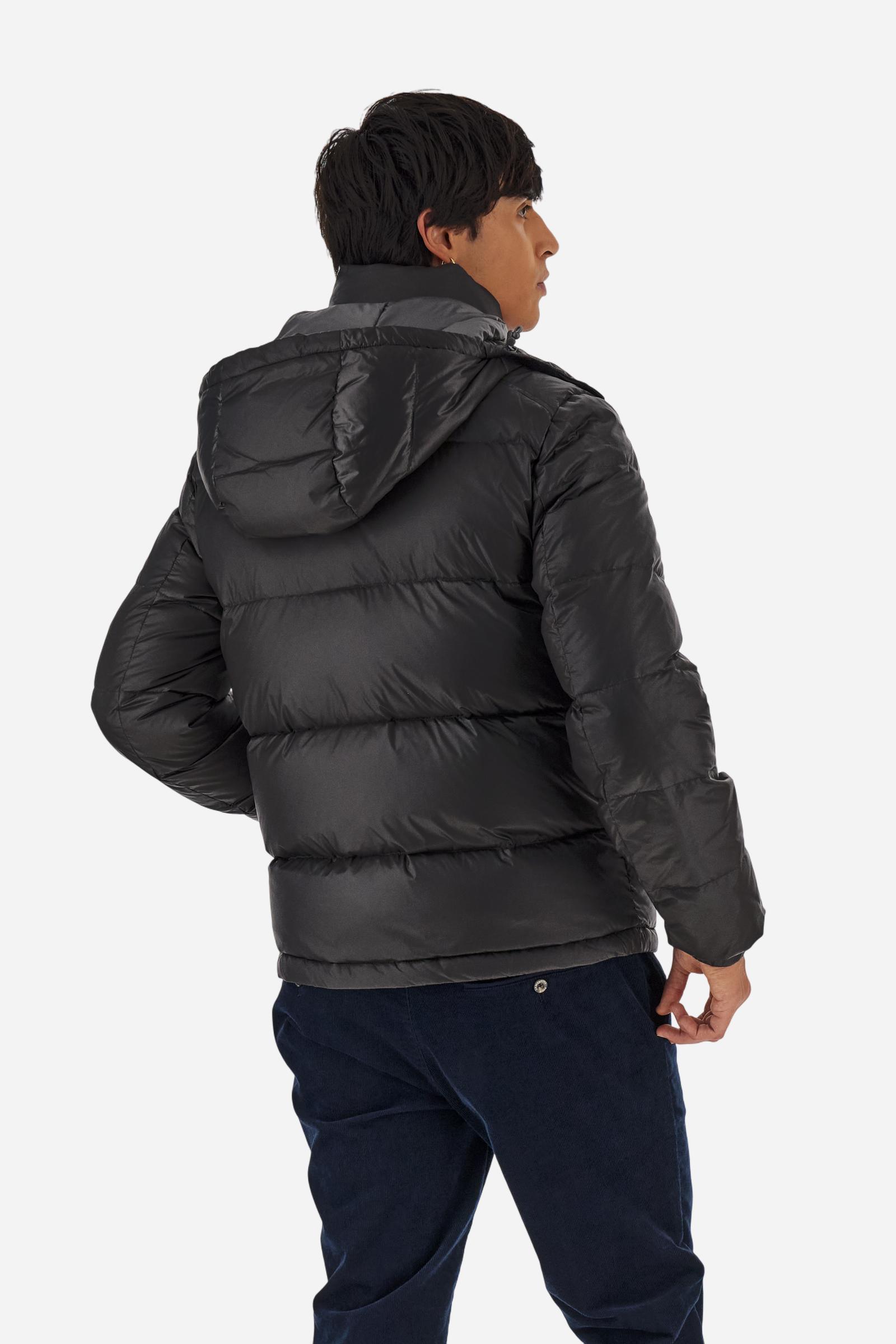 Men’s padded bomber jacket with detachable hood. Made of solid iridescent nylon with contrast lining. Equipped with two practical inner braces for extra comfort. Double customized zip front closure with inner placket featuring contrast Polo Player print, closed with metal snap buttons. Two vertical zipped pockets on the front. Hood with contrast lining and adjustable elastic drawstring. Bold Polo Player graphics printed inside. Regular fit for comfortable movement without bulk. Model wears size L. - Black