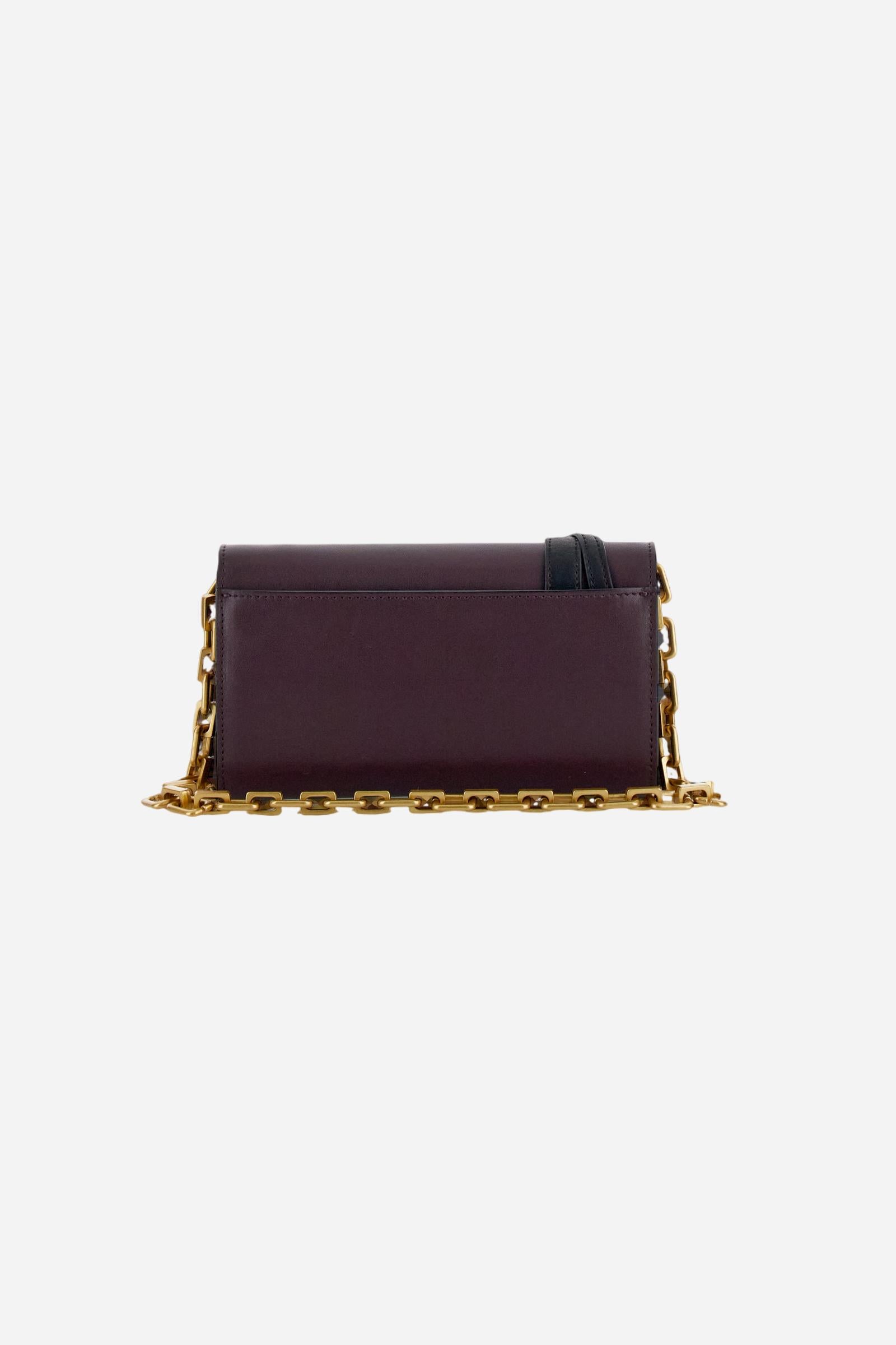Leather chain wallet in soft calfskin with shaped flap and contrasting leather details. Decorated with a small golden buckle and engraved logo. - WINE/BLACK