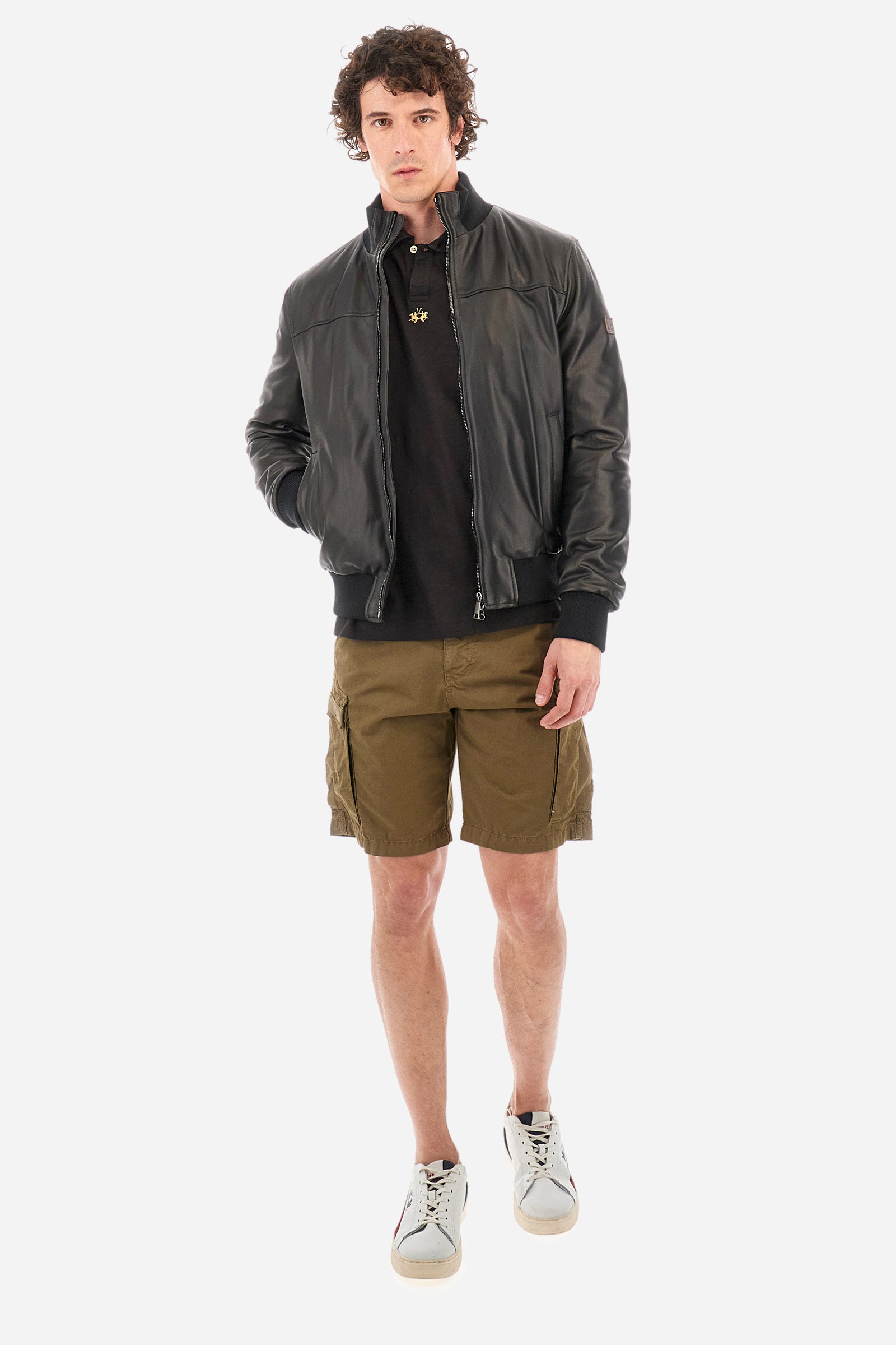 This is the iconic Polo 19-42 from La Martina. Men's short-sleeved polo shirt in solid color made of 100% slub jersey. With a regular fit, it has a collar and a double button closure while the La Martina logo is embroidered in small gold on the front under the placket. Ideal when worn with denim from the collection. Each Polo is kept in an exclusive logoed envelope and is accompanied by a certificate of guarantee. The model is 187 cm tall and wears a size L. - Black