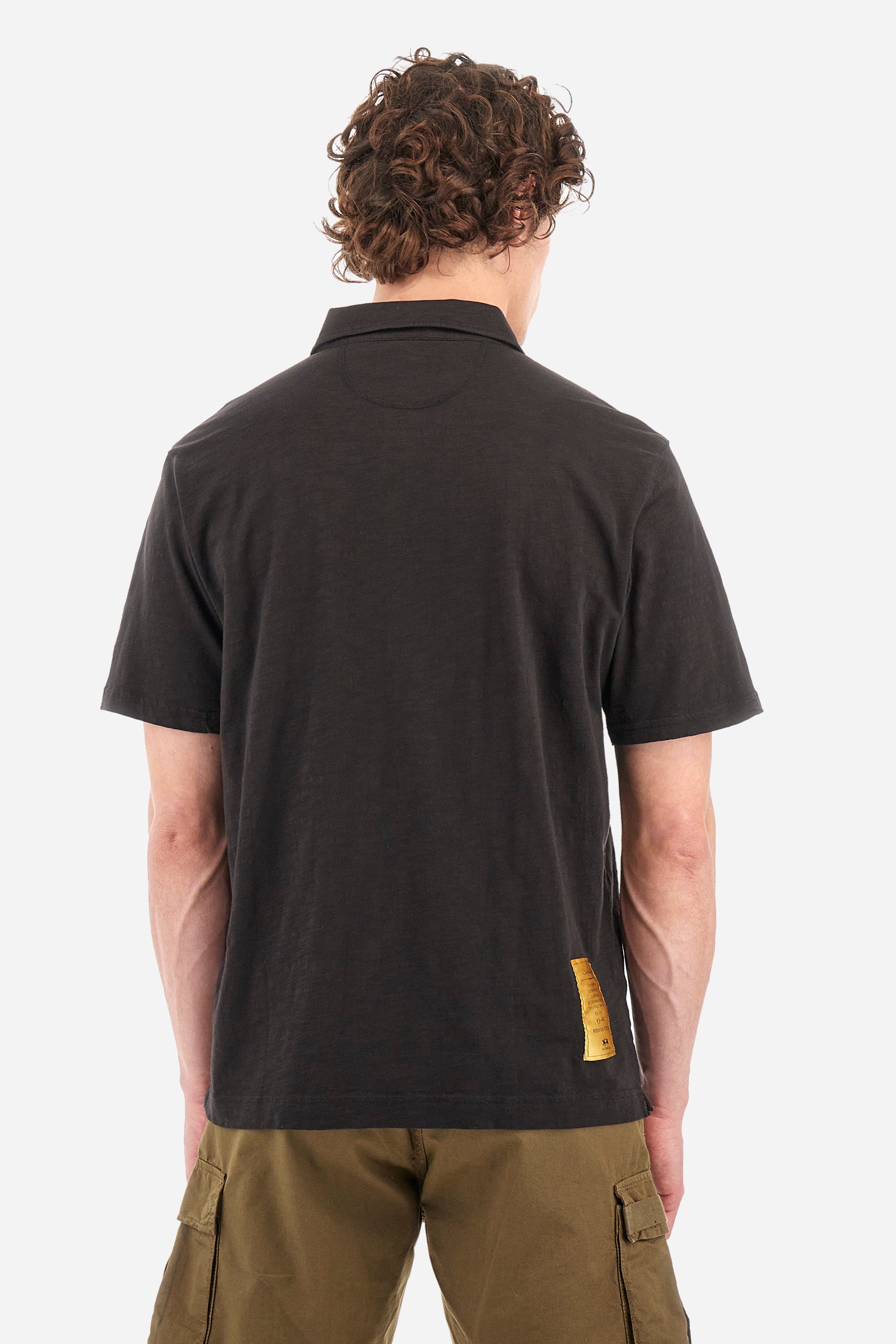 This is the iconic Polo 19-42 from La Martina. Men's short-sleeved polo shirt in solid color made of 100% slub jersey. With a regular fit, it has a collar and a double button closure while the La Martina logo is embroidered in small gold on the front under the placket. Ideal when worn with denim from the collection. Each Polo is kept in an exclusive logoed envelope and is accompanied by a certificate of guarantee. The model is 187 cm tall and wears a size L. - Black