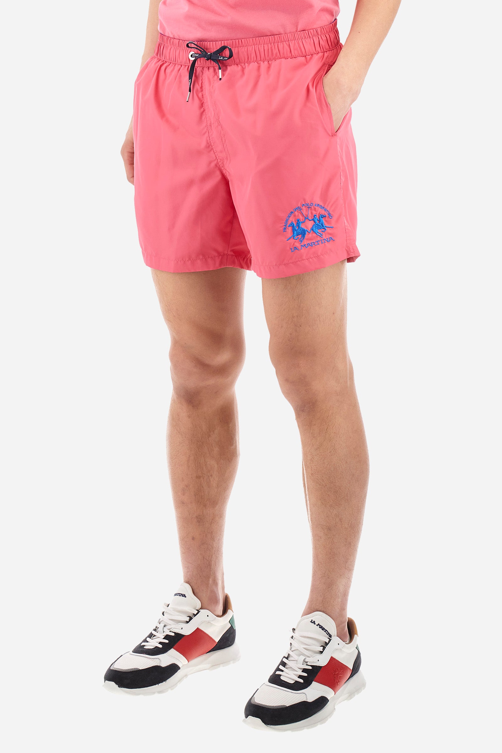 Single-colour men's swimming shorts, made of synthetic fabric. Featuring a drawstring and tie with "La Martina" lettering. Double welt pocket on the front. Closed pocket on the back. Mesh lining. Large logo embroidered on the front. The fit is regular. The model wears a size L. - Hot Pink