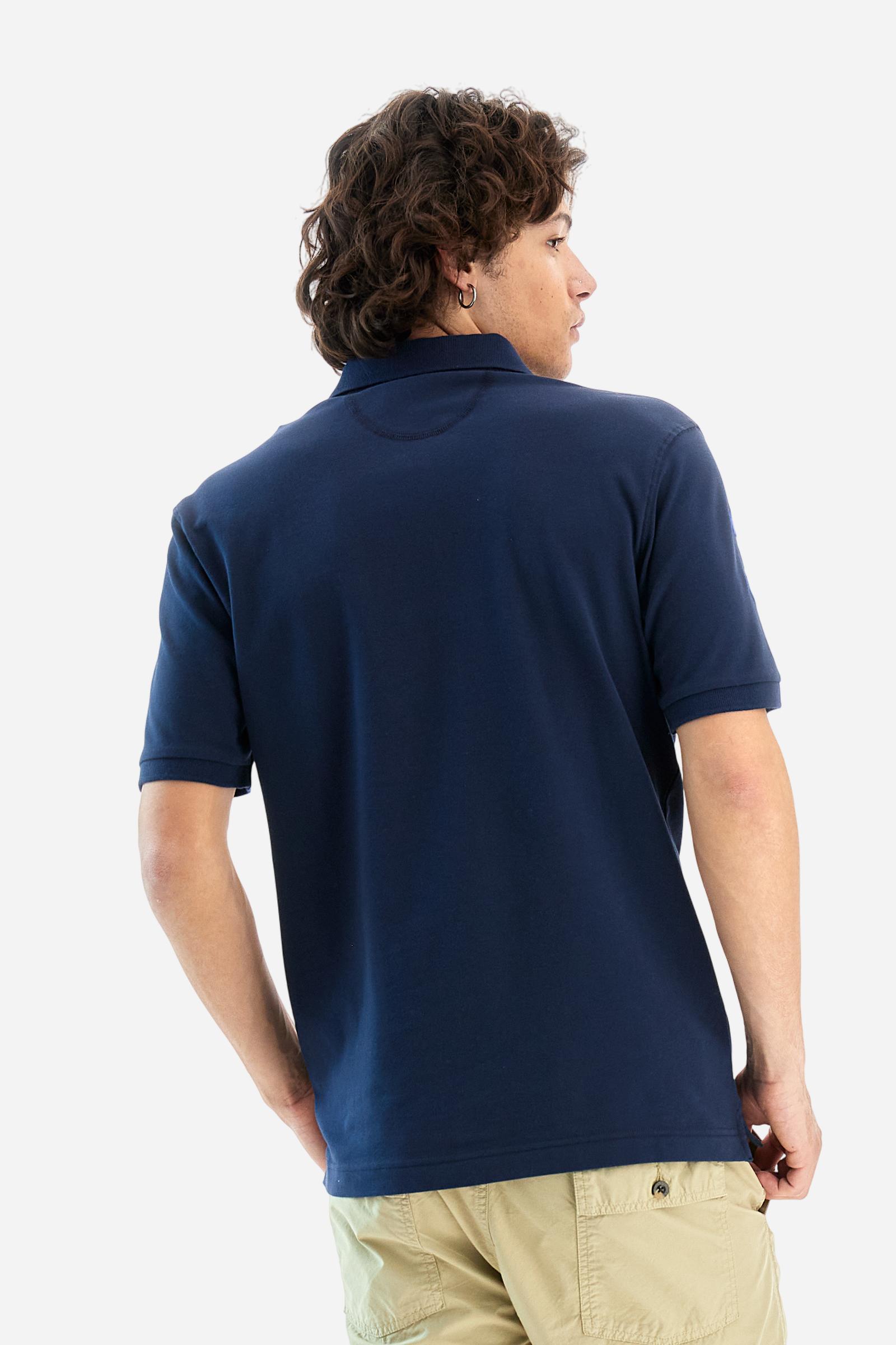 Men's plain short-sleeved polo shirt made from stretch piqué. Two-button fastening. The collar and cuffs are made from tone-on-tone ribbed fabric. A contrasting fabric patch depicting the number 3 is appliquéd on the right sleeve. The logo is embroidered on the left side of the chest in contrasting thread. Under the collar, there is a large contrasting print of the La Martina lettering. Regular fit. The model is wearing a size L. - Navy