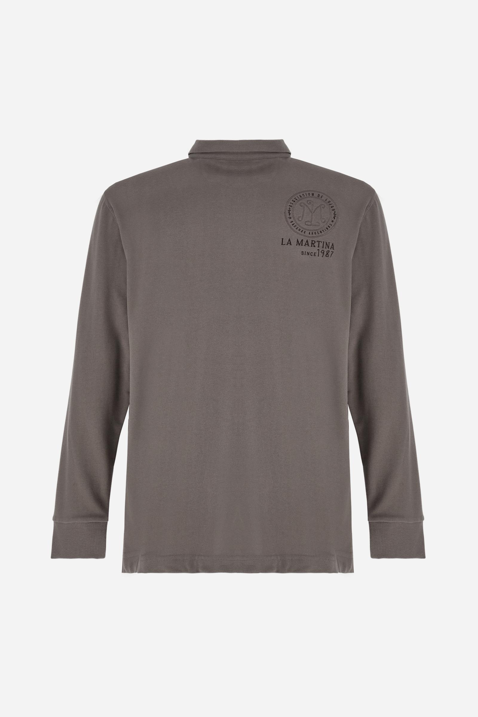 Long-sleeve polo shirt crafted from 100% high-quality cotton jersey. The velvety fabric offers a warm, cozy feel, perfect for cooler seasons. Ribbed collar and cuffs in matching tone, with a three-button personalized placket. A small multicolor embroidered logo sits below the opening, while tonal patches in different shapes and textures, inspired by Argentine culture and Gaucho tradition, decorate the chest and back. Classic regular fit. Model wears size L. - Falcon