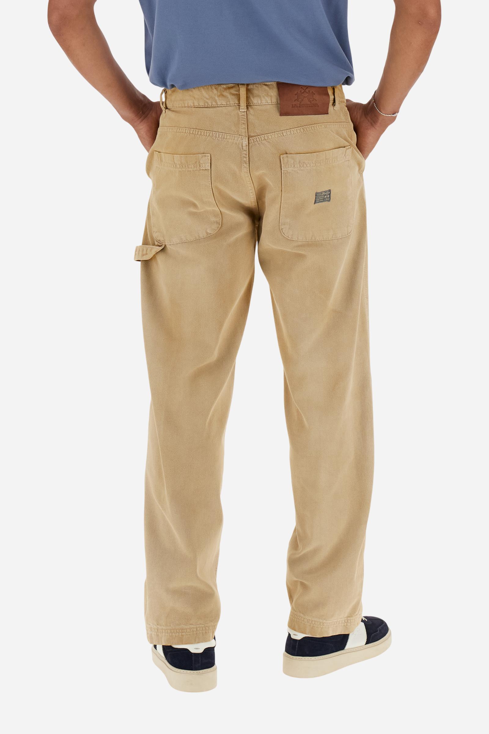 Men's Carpenter trousers in pure bull cotton. The classic five-pocket construction features a relaxed fit through the hips and thighs, with straight, wide legs.The fabric undergoes an authentic faded treatment that gives it a lived-in character and a used effect with contemporary appeal. The brand's guarantee label is applied to the back pocket, while the logo appears on a faux leather patch attached to the back of the wasitband.The model is wearing a size 33. - Bone Brown
