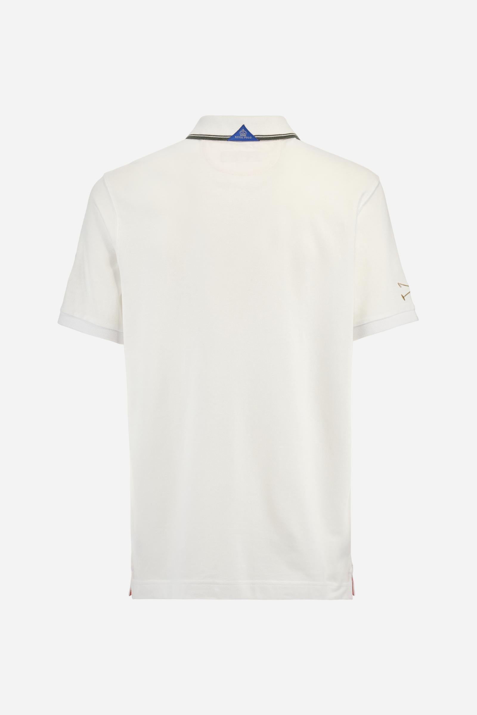 Men's short-sleeved Guards polo shirt in a single colour, made of cotton piqué. Fastens with two buttons. The collar is ribbed with striped trim in a contrasting colour. The graphics on the chest and sleeves are all made using the embroidery technique. The central lettering on the chest is a 3D embroidery in the same colour as the base fabric. The large colour-contrasting logo is embroidered on the chest. The fit is regular. The model is wearing a size L. - Optic White