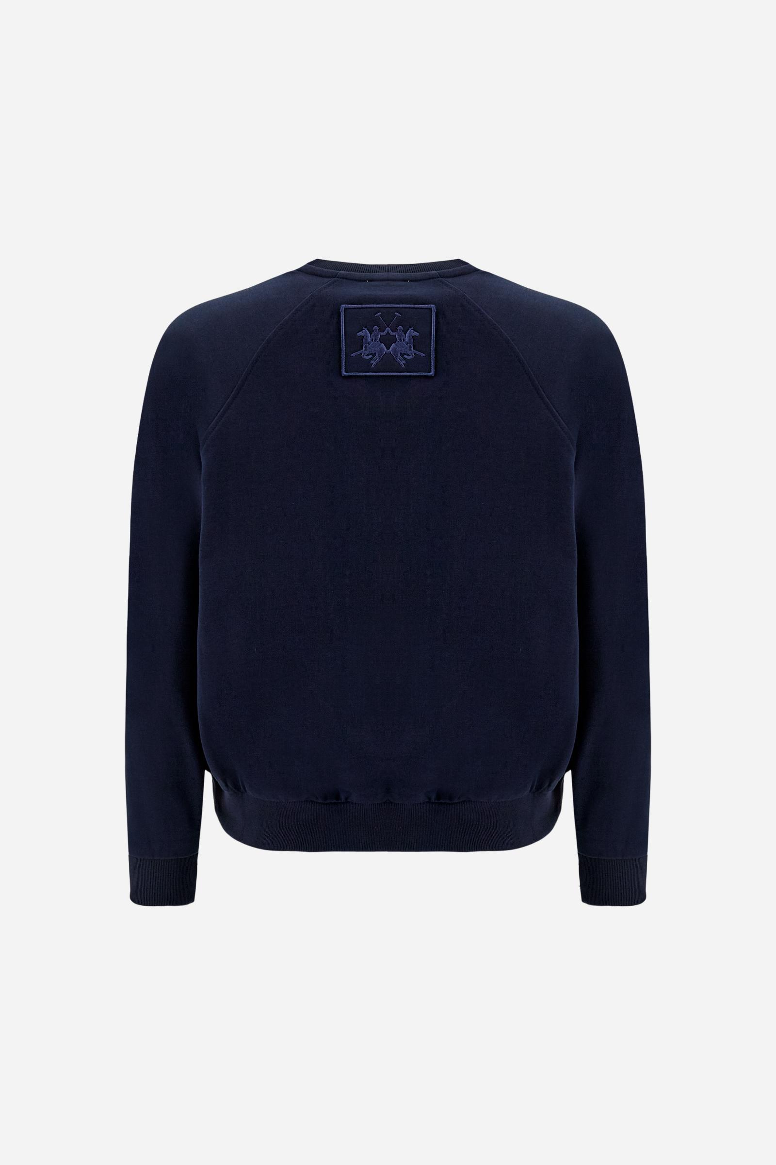 Women’s long-sleeve cotton sweatshirt. Relaxed-fit style with raglan sleeves, soft volume and regular length, finished with ribbed details and embroidered logo patch below the collar. - Navy