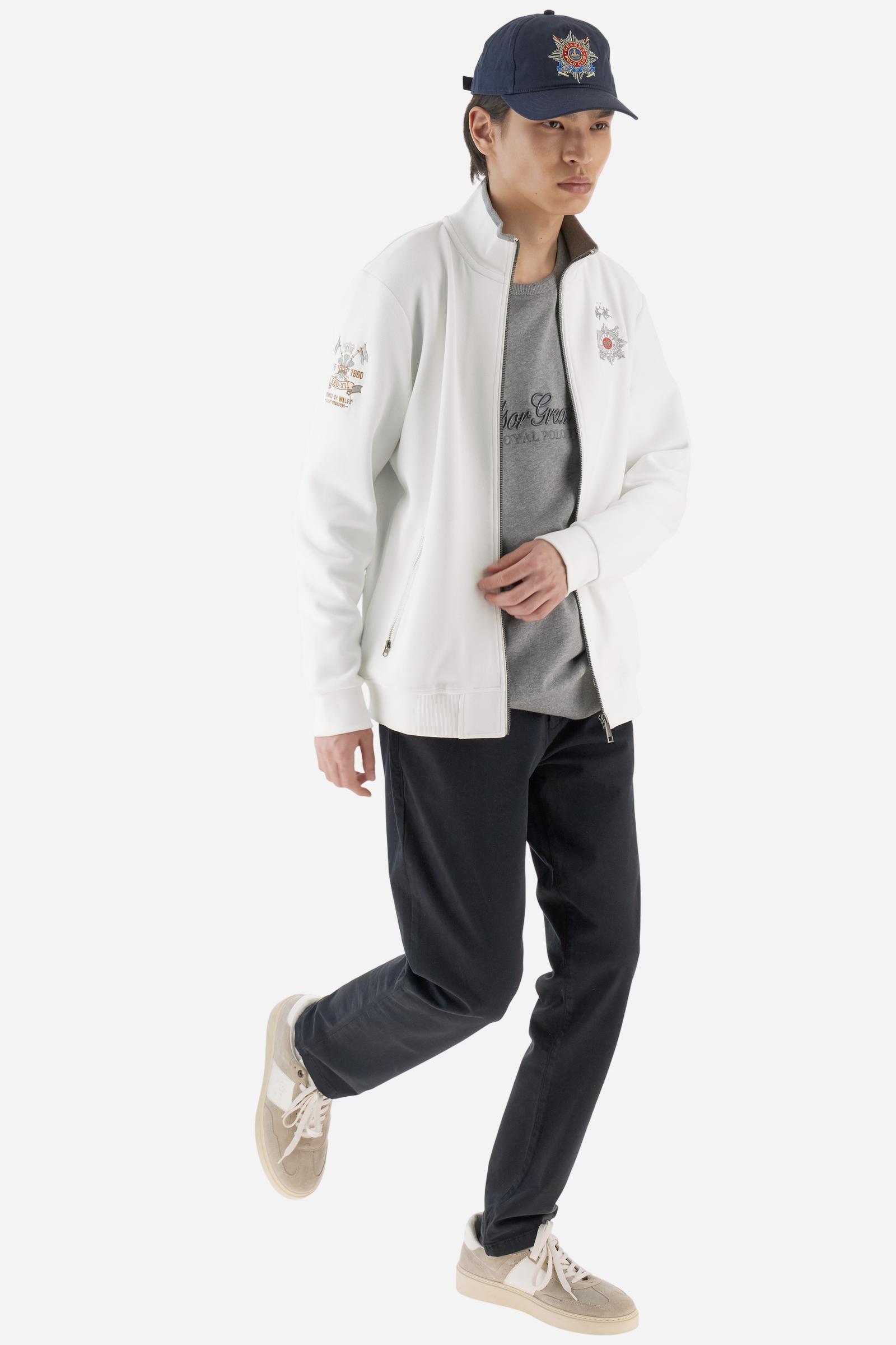 Men's long-sleeved, full-zip solid colour sweatshirt. Made of stretch cotton-blend piqué. Design with front opening fastened by a zip, high collar in two-tone ribbing. Solid colour ribbed cuffs and waistband. The small brand logo and Guards crest are embroidered in multi-coloured thread on the chest. On the right sleeve, there is another embroidery of a crest inspired by the British royal household. The regular fit silhouette is practical for everyday wear. The model is wearing a size L. - Off White