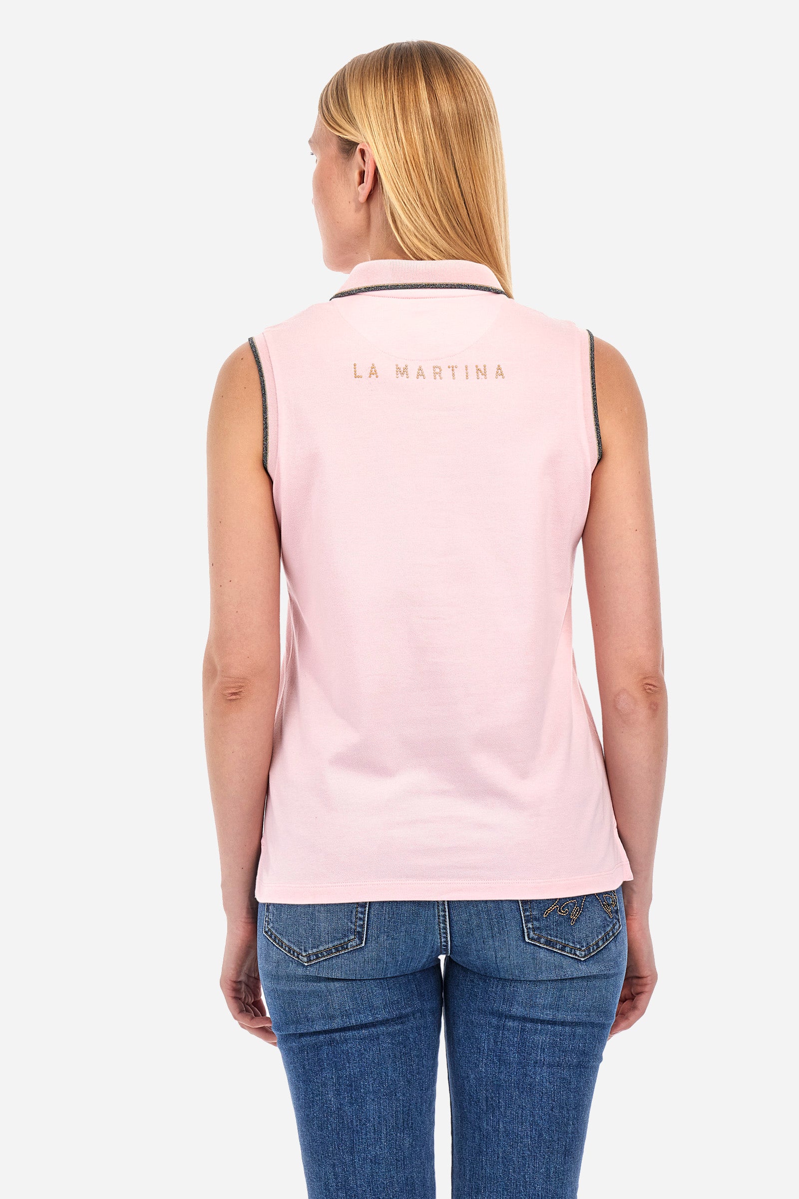 Women’s sleeveless polo shirt in solid color, made of stretch cotton. V-neck and 2 button closure. Collar and crew sleeves profiled and ribbed. Side slits. On the back there is the inscription "La Martina" composed of small rhinestones. The logo is present on the front. The fit is regular. The model wears a size 2 . - Almond Blossom