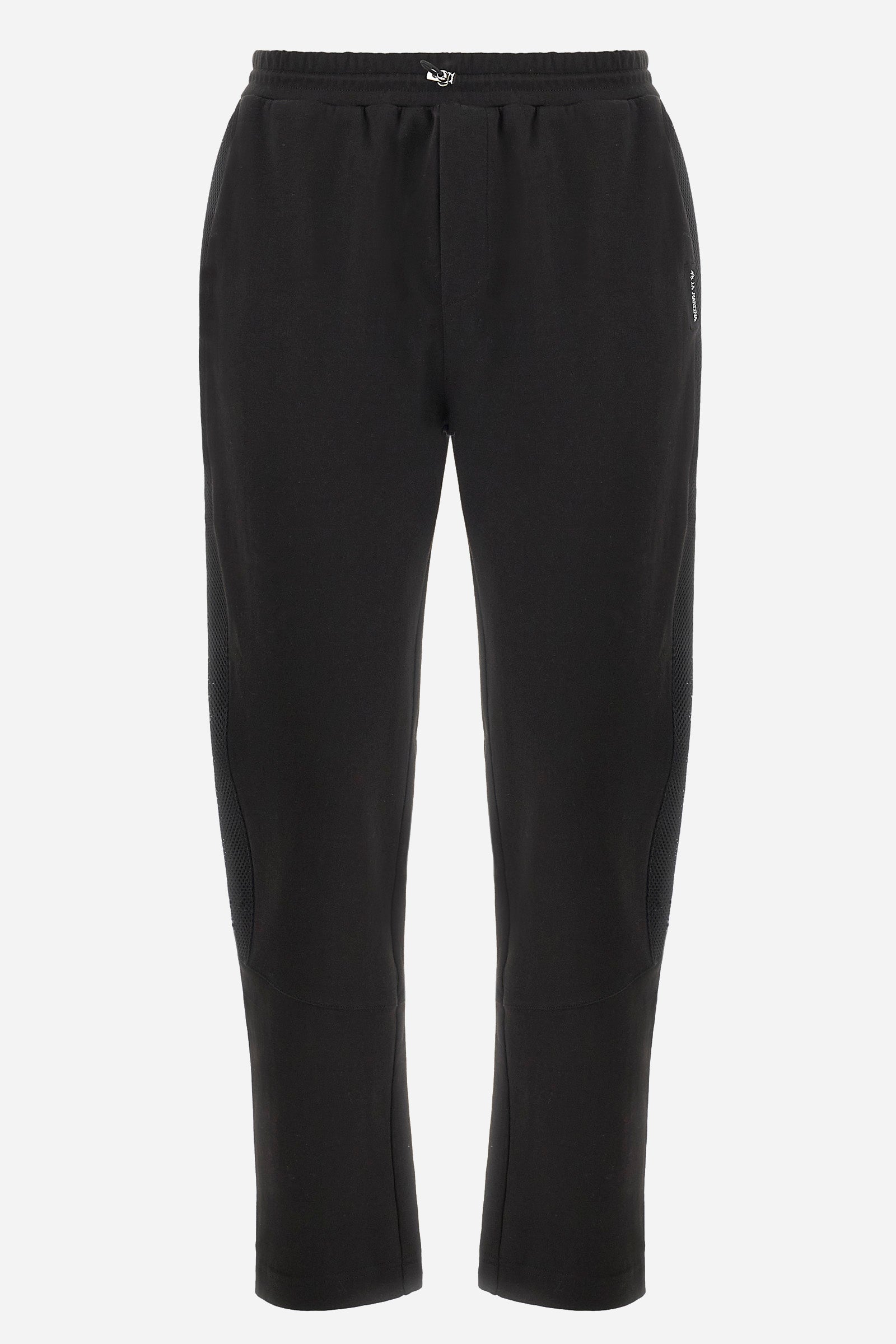 Men's single-colour jogging bottoms in mixed cotton. Drawstring at the waist and double welt pocket on the front. Featuring a side stripe with a honeycomb texture. On the back there is a single open pocket featuring the brand's initials. The fit is regular. The model wears a size L. - Black