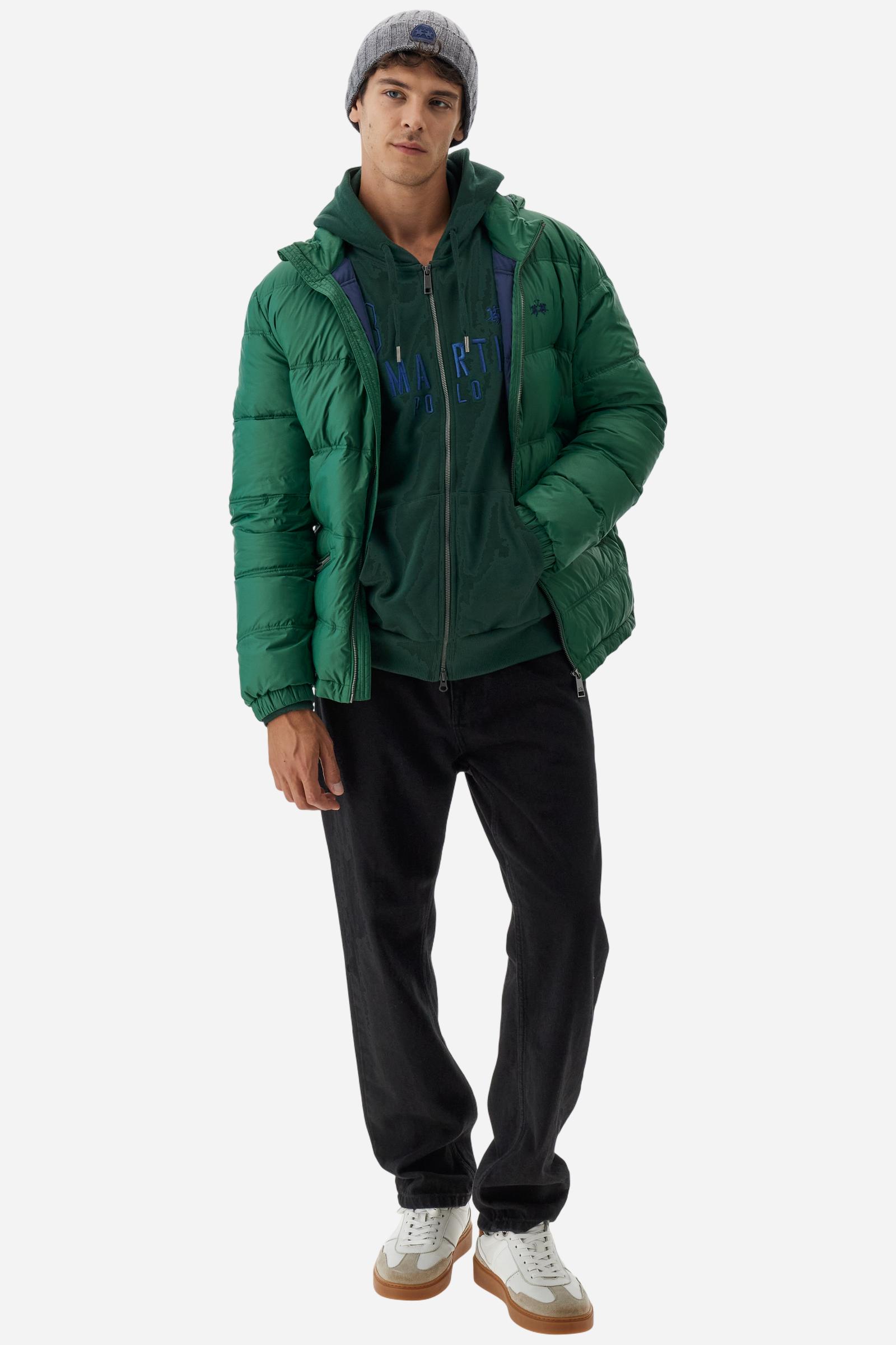 Men's long-sleeved hoodie in solid colour, made from soft 100% cotton fleece with a velvety touch. The model features a customised front zip and an adjustable hood with drawstring. Hem and cuffs in tone-on-tone rib. Iconic brand graphics stand out on the chest, embroidered with numbers and lettering. Regular fit ensuring comfort and freedom of movement. Model wears size L. - Sycamore