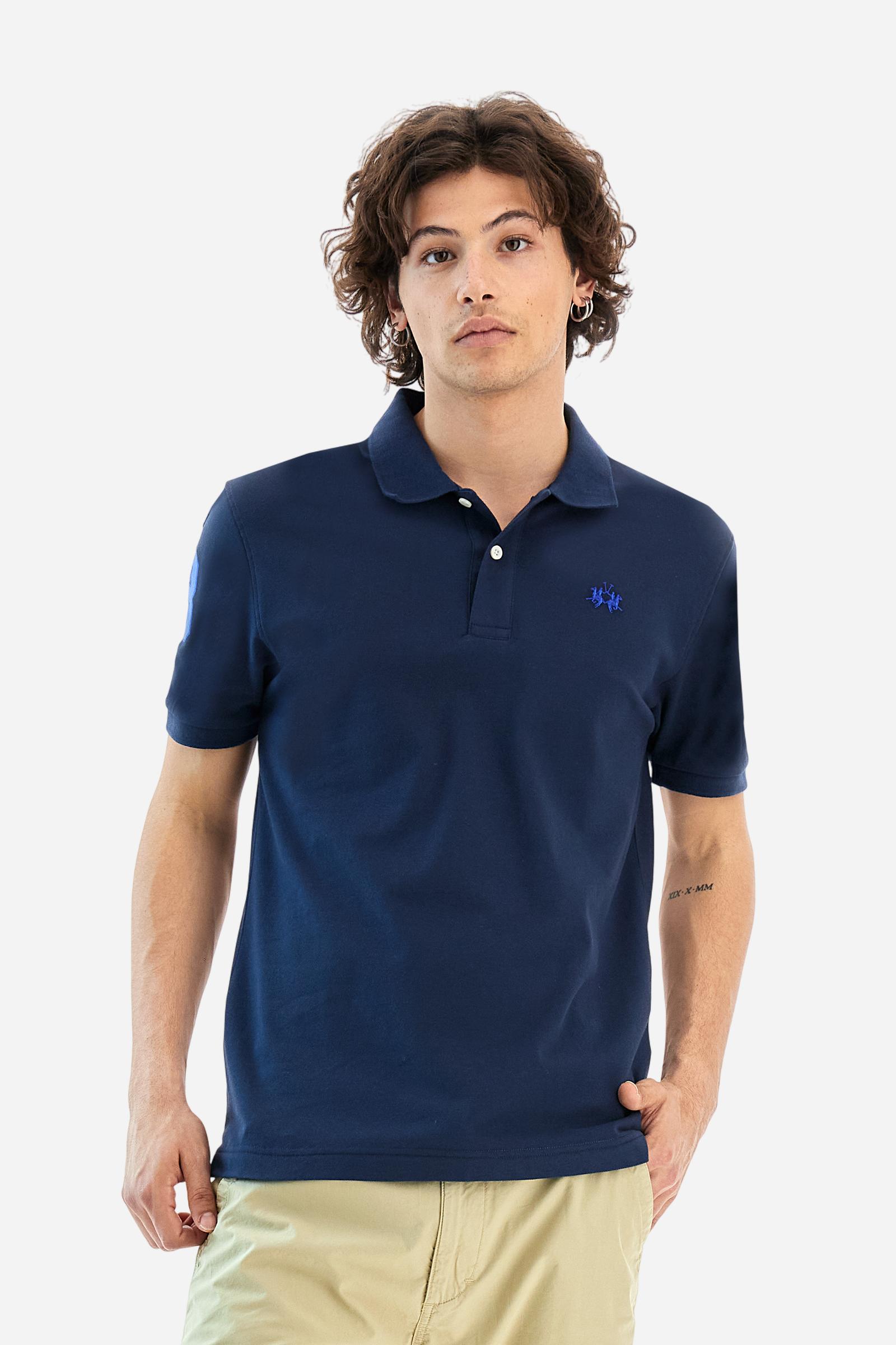 Men's plain short-sleeved polo shirt made from stretch piqué. Two-button fastening. The collar and cuffs are made from tone-on-tone ribbed fabric. A contrasting fabric patch depicting the number 3 is appliquéd on the right sleeve. The logo is embroidered on the left side of the chest in contrasting thread. Under the collar, there is a large contrasting print of the La Martina lettering. Regular fit. The model is wearing a size L. - Navy