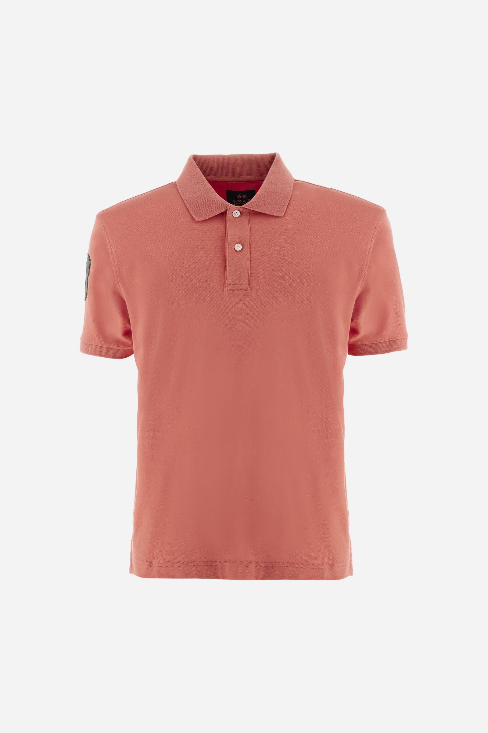 Men's plain short-sleeved polo shirt made from stretch piqué. Two-button fastening. The collar and cuffs are made from tone-on-tone ribbed fabric. A contrasting fabric patch depicting the number 3 is appliquéd on the right sleeve. The logo is embroidered on the left side of the chest in contrasting thread. Under the collar, there is a large contrasting print of the La Martina lettering. Regular fit. The model is wearing a size L. - Acai