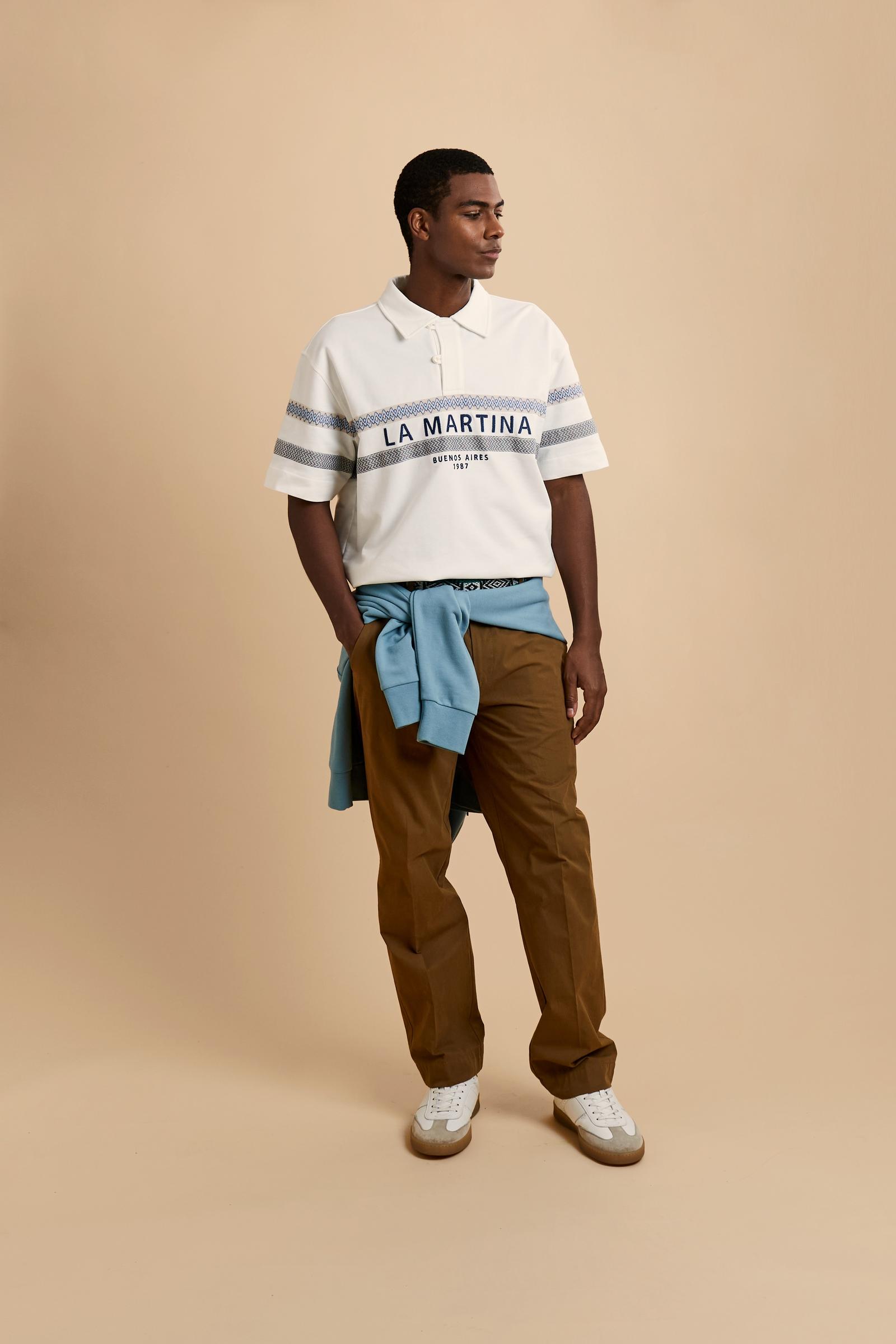 Short-sleeve polo in heavy cotton jersey with a compact structure and substantial hand feel. Contemporary fit with relaxed volume and slightly dropped shoulders. Classic collar with visible placket and bold horizontal band with geometric multicolor tapes. Raised “La Martina” embroidery on the chest and contrasting 3D logo on the back. - Off White