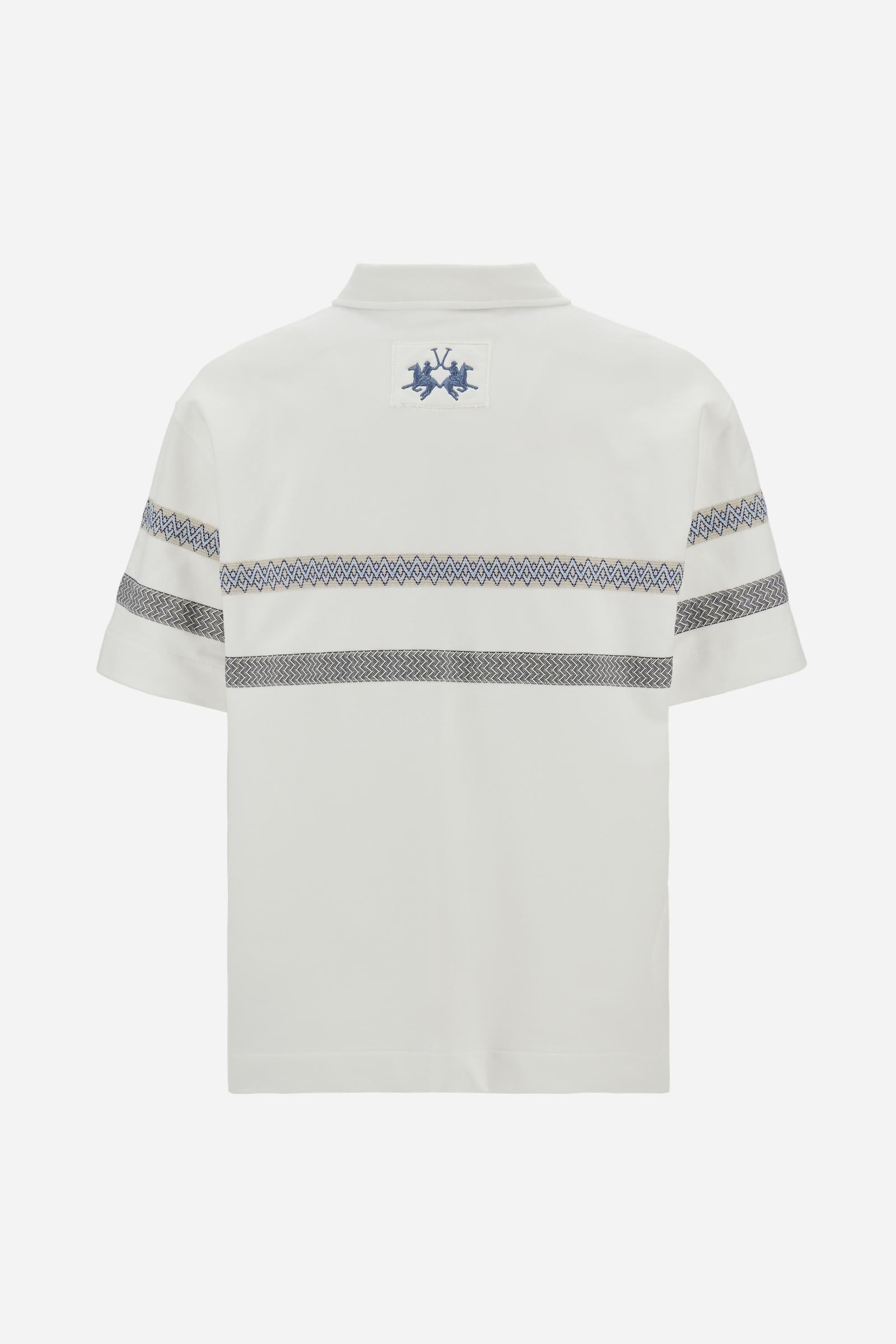 Short-sleeve polo in heavy cotton jersey with a compact structure and substantial hand feel. Contemporary fit with relaxed volume and slightly dropped shoulders. Classic collar with visible placket and bold horizontal band with geometric multicolor tapes. Raised “La Martina” embroidery on the chest and contrasting 3D logo on the back. - Off White