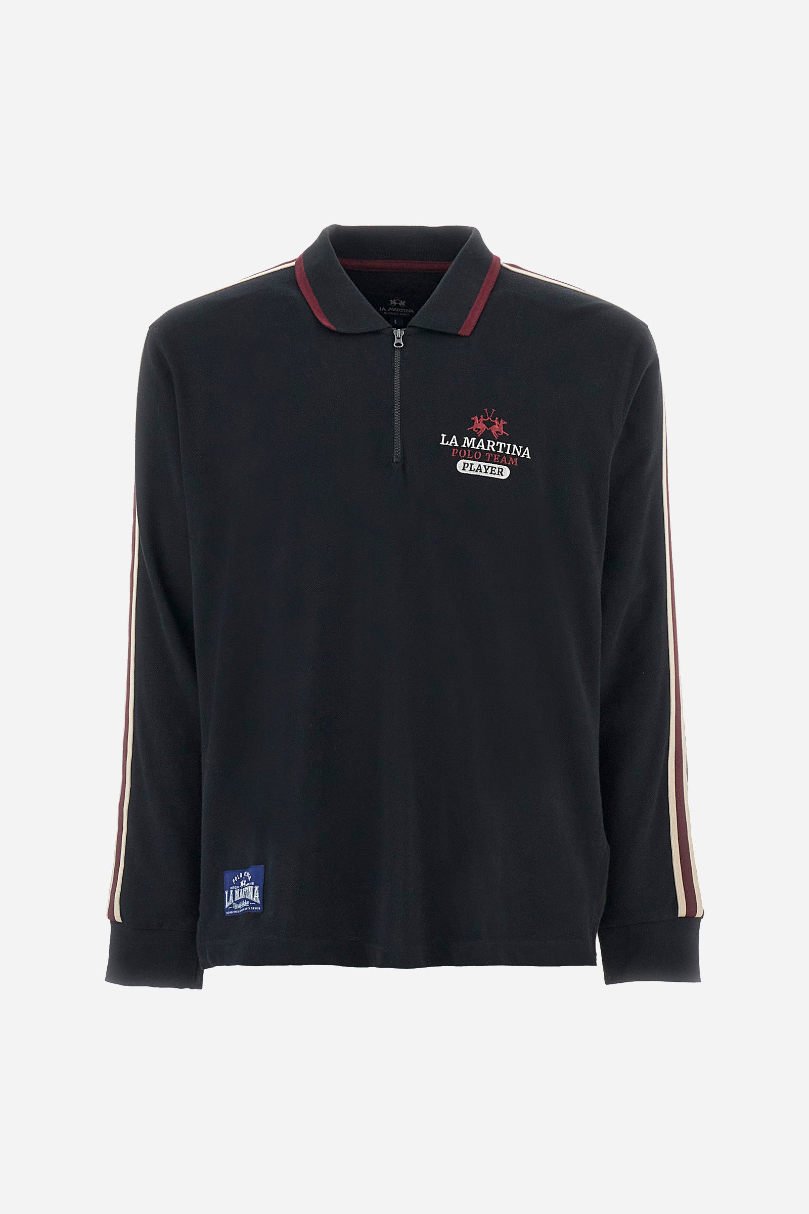 Men's plain short-sleeved polo shirt, made from 100% cotton. Half-zip fastening. Trimmed collar. The sleeves are finished with contrasting stripes. The symbols and lettering associated with the Harvard line are appliquéd on the back. The front is embroidered with the logo and La Martina lettering. Regular fit. The model is wearing a size L. - Black