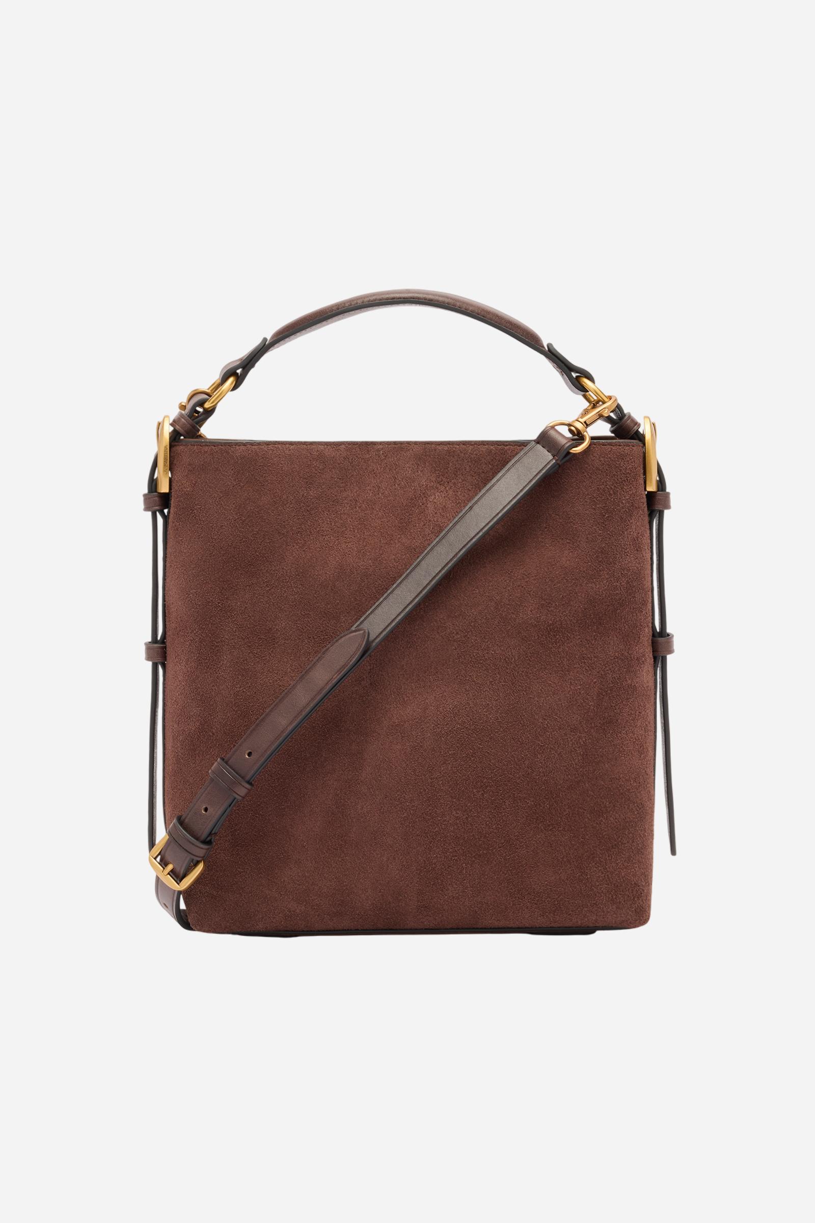 Compact square-shaped tote bag crafted from soft solid-colour suede. Featuring a structured top handle and a detachable leather shoulder strap. Gold-tone metal details and a front logo plaque complete the elegant, understated design. Dimensions:22 x 23 x 11 - D.BROWN/D.CHOCOLATE