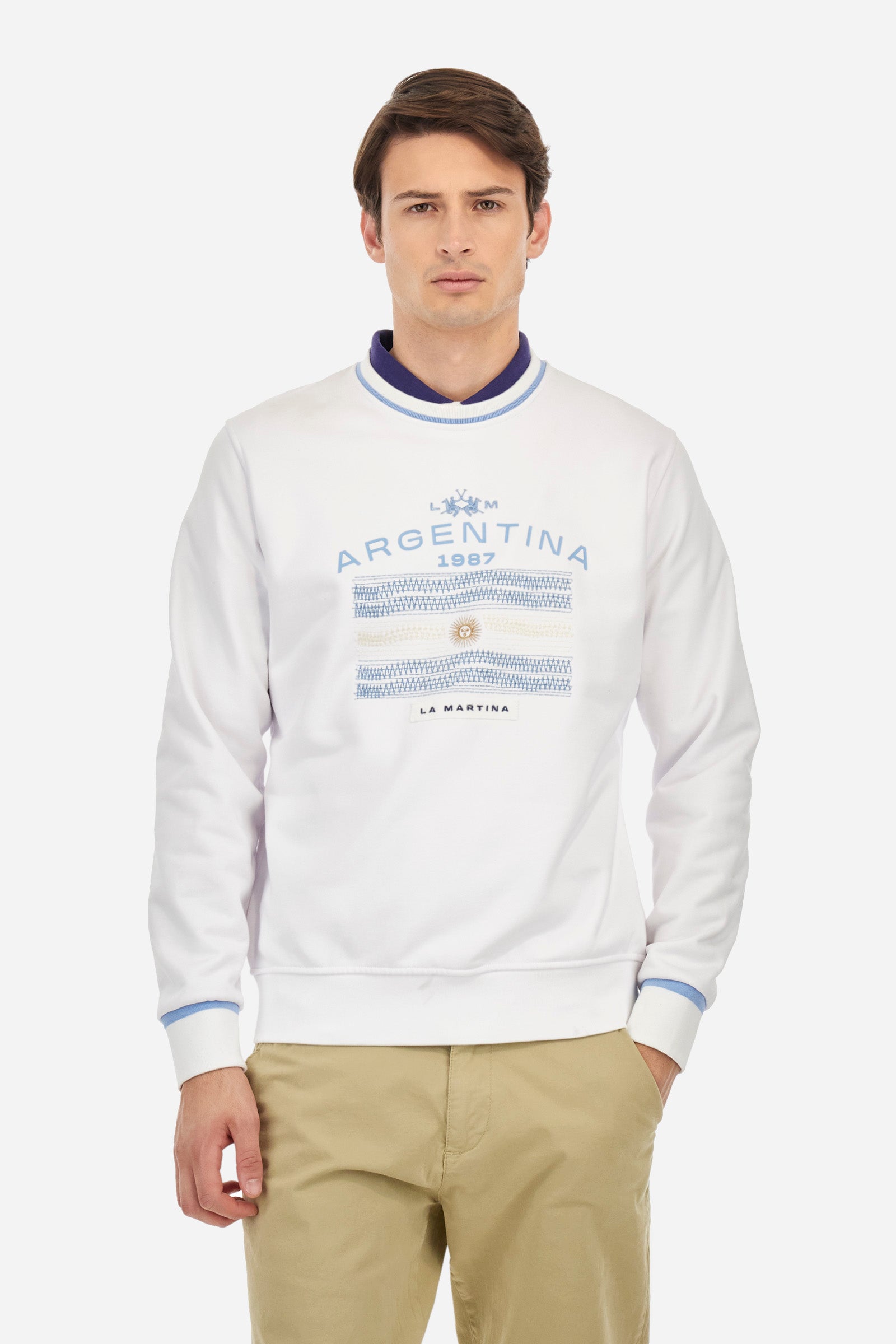 Men's crew-neck sweatshirt with long sleeves, single colour. Made in French terry cotton. The collar and cuffs are ribbed with a contrasting trim, while the waistband is also ribbed but in a matching colour. The large embroidery on the chest combines classic techniques, with workmanship that recalls a handmade spirit, together with the logo and initials of the brand. Regular fit. The model is wearing a size L. - Optic White