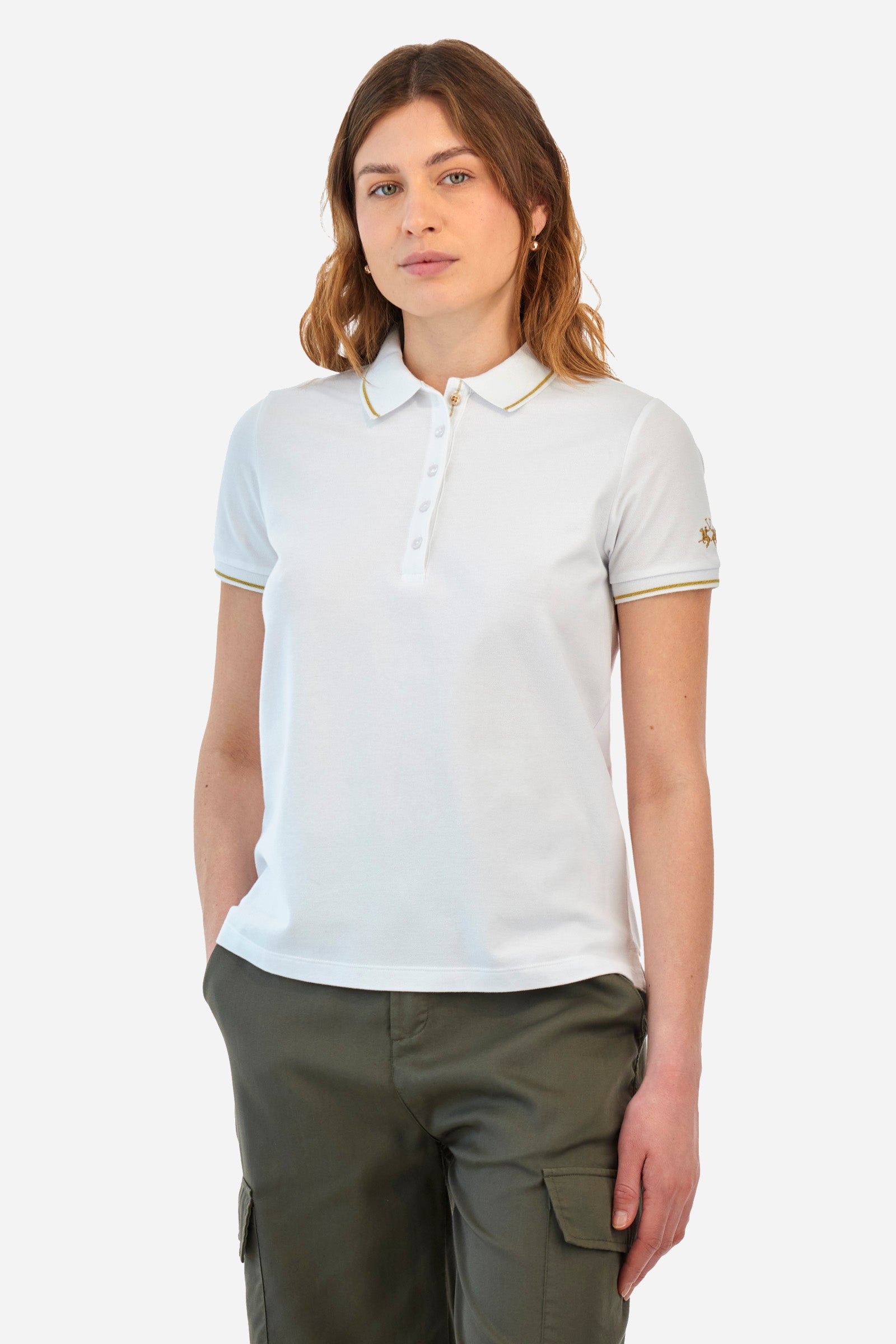 Women’s polo with short sleeves in solid color, made of stretch cotton. 5-button closure. Collar and crew sleeves profiled and ribbed. Side slits. Under the collar there is the inscription "La Martina". The logo is embroidered on a sleeve and embellished with the application of some rhinestones. The fit is regular. The model wears a size 2. - Optic White
