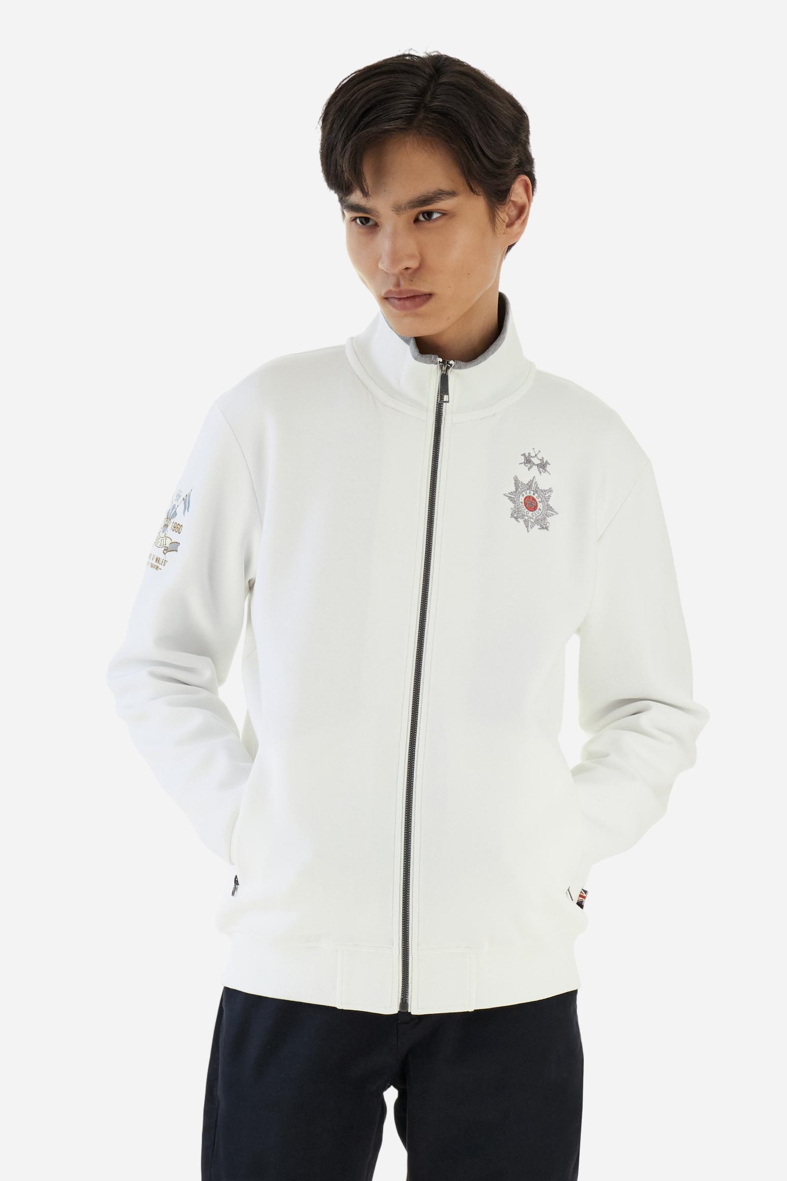 Men's long-sleeved, full-zip solid colour sweatshirt. Made of stretch cotton-blend piqué. Design with front opening fastened by a zip, high collar in two-tone ribbing. Solid colour ribbed cuffs and waistband. The small brand logo and Guards crest are embroidered in multi-coloured thread on the chest. On the right sleeve, there is another embroidery of a crest inspired by the British royal household. The regular fit silhouette is practical for everyday wear. The model is wearing a size L. - Off White